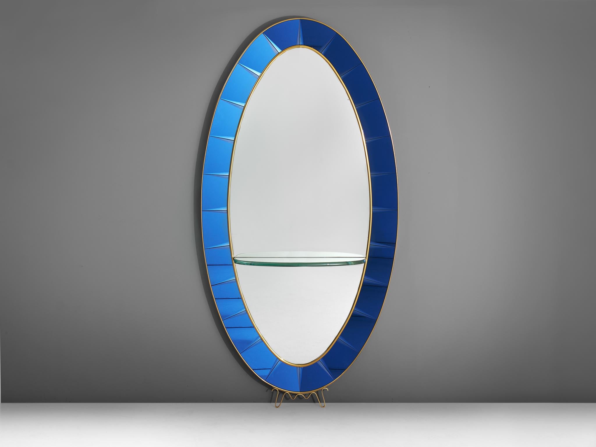Cristal Arte, mirror, blue glass, Italy, 1950s.

The mirror is surrounded by beveled blue glass panels, placed in a gilt brass and wooden frame. The glass panels have been very well executed in typically Cristal Arte cobalt blue. The brass frame