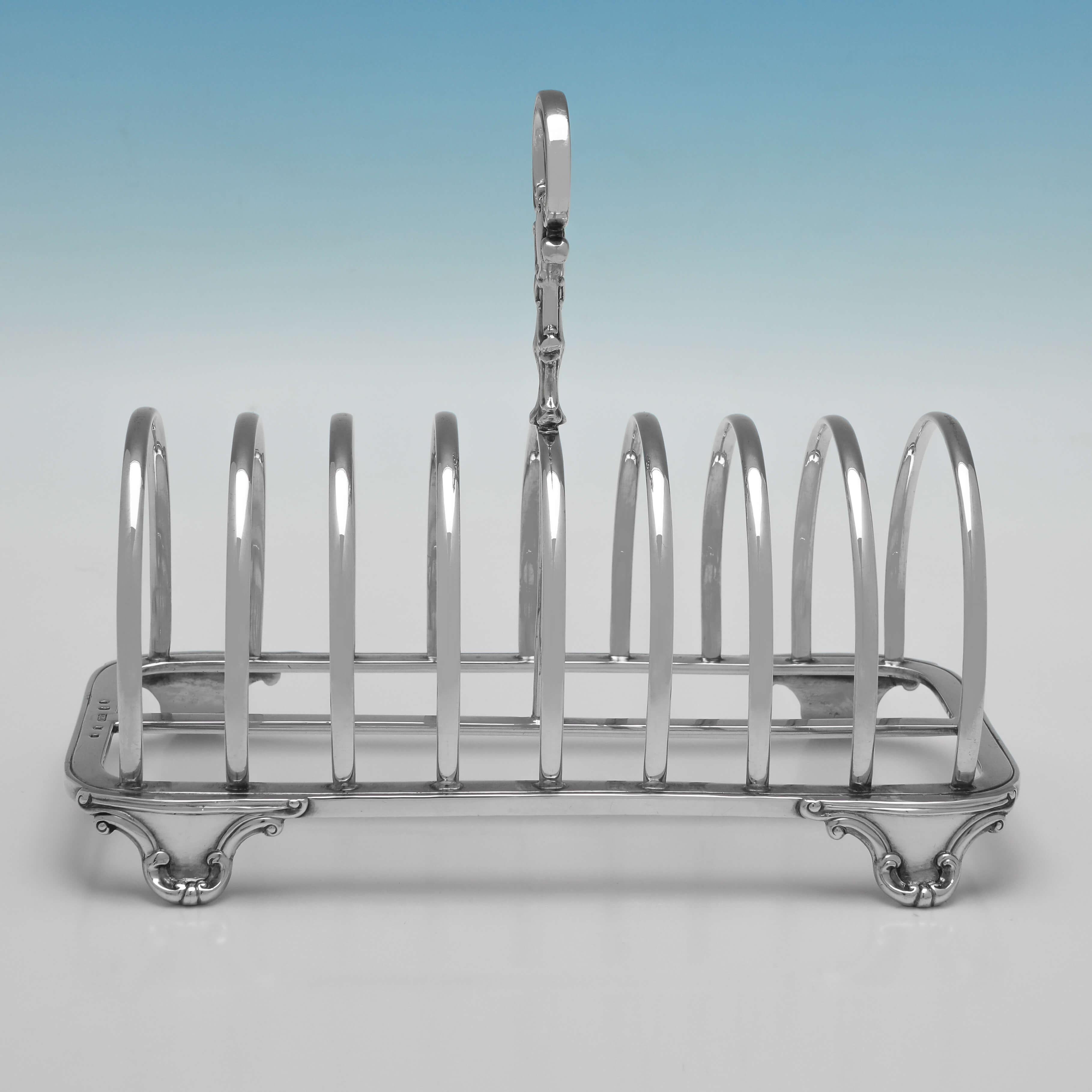 Hallmarked in Edinburgh in 1843 by James McKay, this handsome, Victorian, Antique Sterling Silver Toast Rack, features shaped feet, an ornate handle, and will hold 8 pieces of toast. 

The toast rack measures 6.25