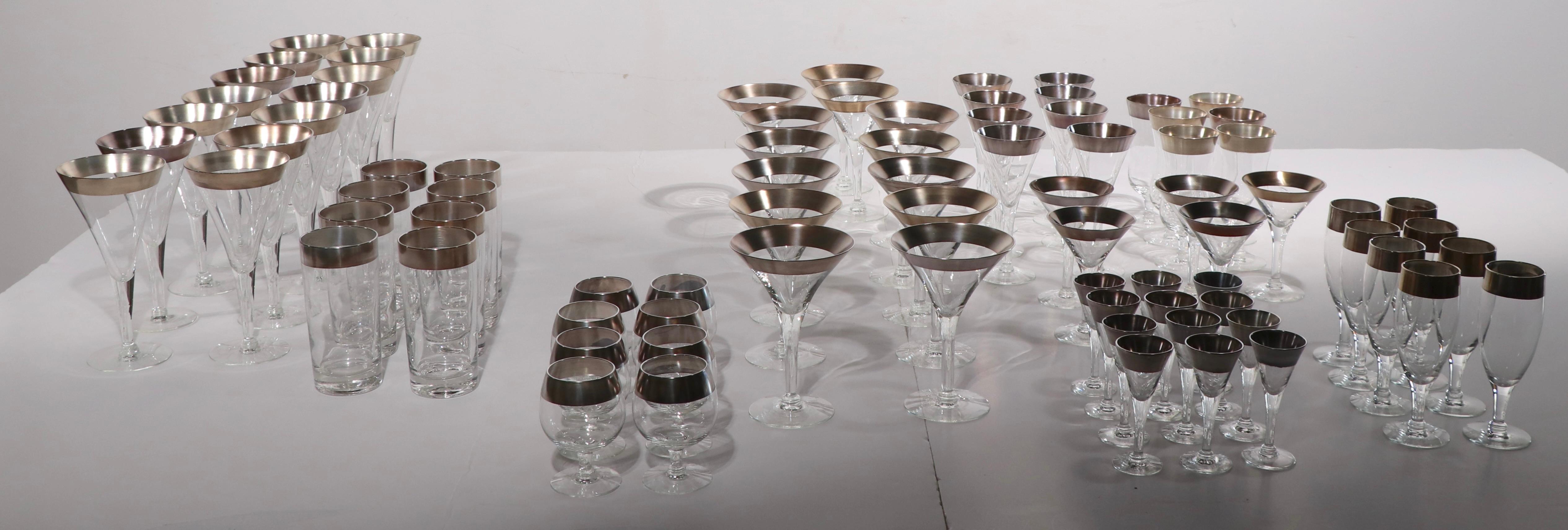 Incredible complete set of silver band glassware, almost impossible to find this intact. The set consists of 9 sizes, with a total of 82 pieces. 
 12 Cordials 4.25 Height x 1.75 Diameter.
 14 Large Wines 7.5 Height x 4 Diameter.
 8 Brandy Glasses