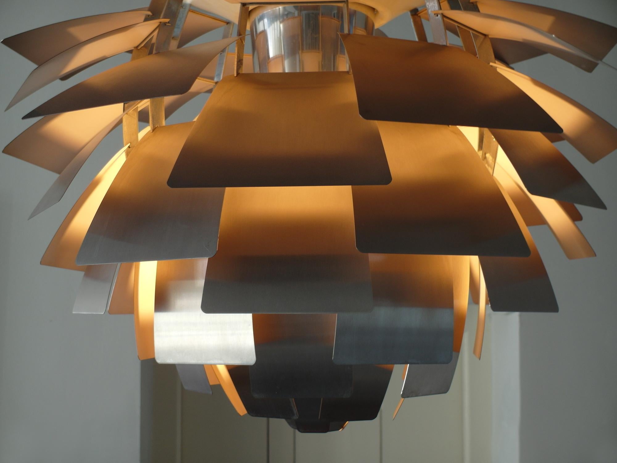 Largest edition of the PH-Artichoke pendant with brushed stainless steel shades designed by Poul Henningsen for Louis Poulsen, Denmark, design 1957, production 1970s. 
This iconic pendant has 72 brushed steel shades in twelve layers of 6 shades