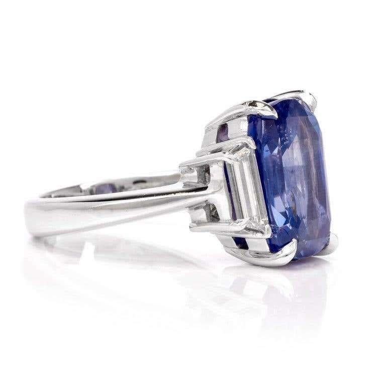 This high-quality three stone sapphire and diamond ring is crafted in solid platinum. 
Displaying a prominent cushion-cut, Natural No Heat Genuine Blue Sapphire with GIA lab report weighing approx. 9.07 carats and measuring 13.28 x 9.41 x 6.67mm.