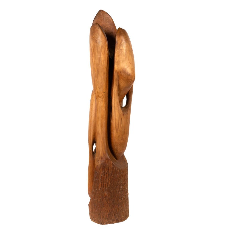 This large and narrow wood abstract sculpture in a golden honey colour has been carved from a single piece of wood.
It is unsigned but it comes from a long time collector from Quebec.