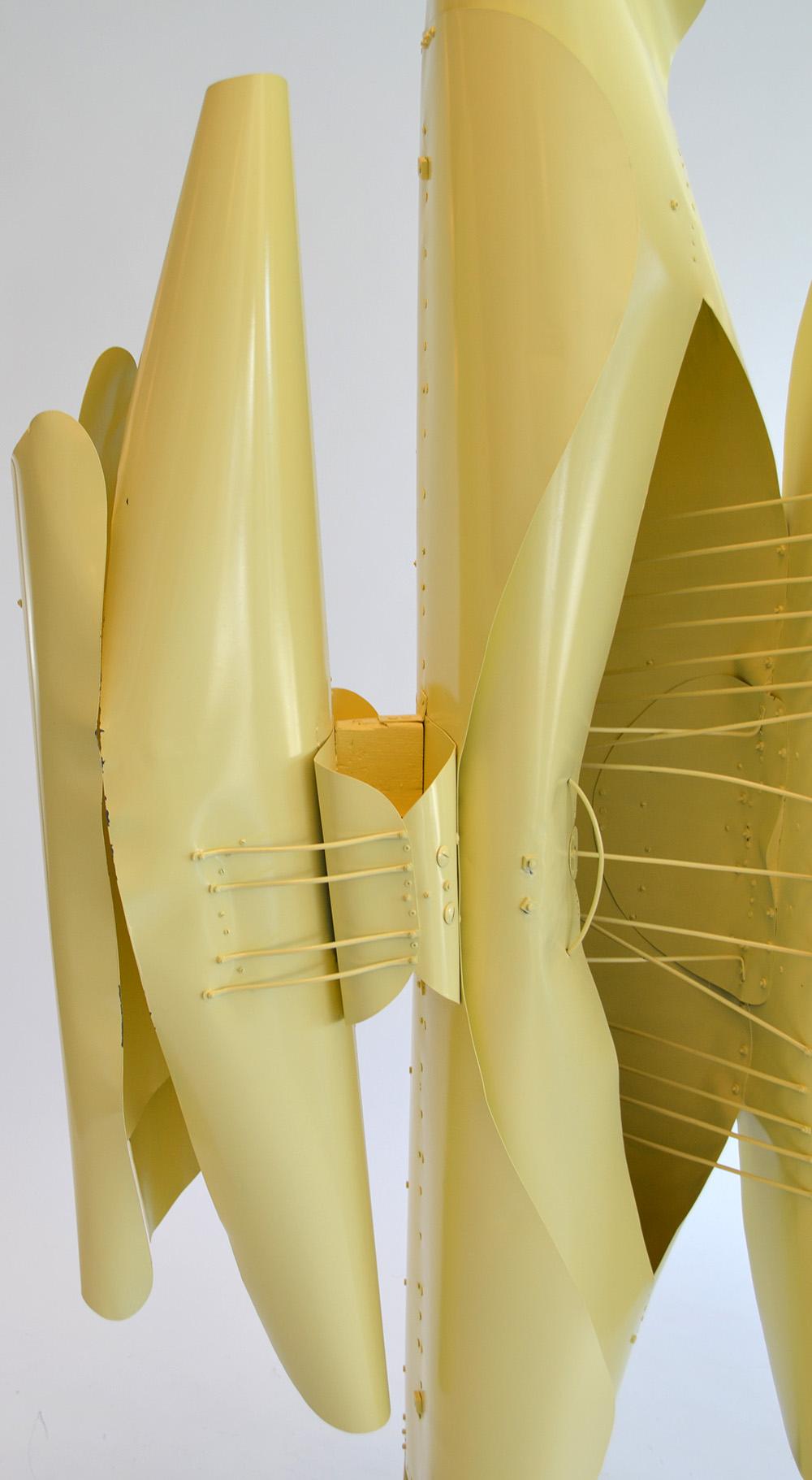 Large abstract folded metal sculpture by Victor Roman (1937-1995) 1970's. Constructed of butter-yellow painted folded metal with Barbara Hepworth-inspired struts and supports on a painted wood base/plinth. Some dings and paint loss. Unsigned. Prov.
