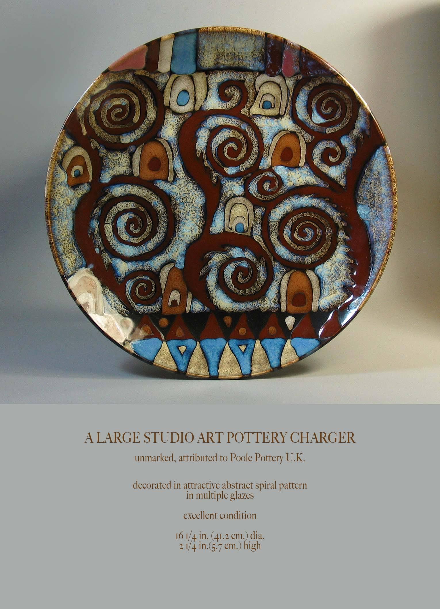A large Abstract Studio Art Pottery charger, unmarked, attributed to Poole Pottery U.K. Decorated in attractive an abstract spiral pattern in multiple glazes, excellent condition. The charger measures 16 1/4