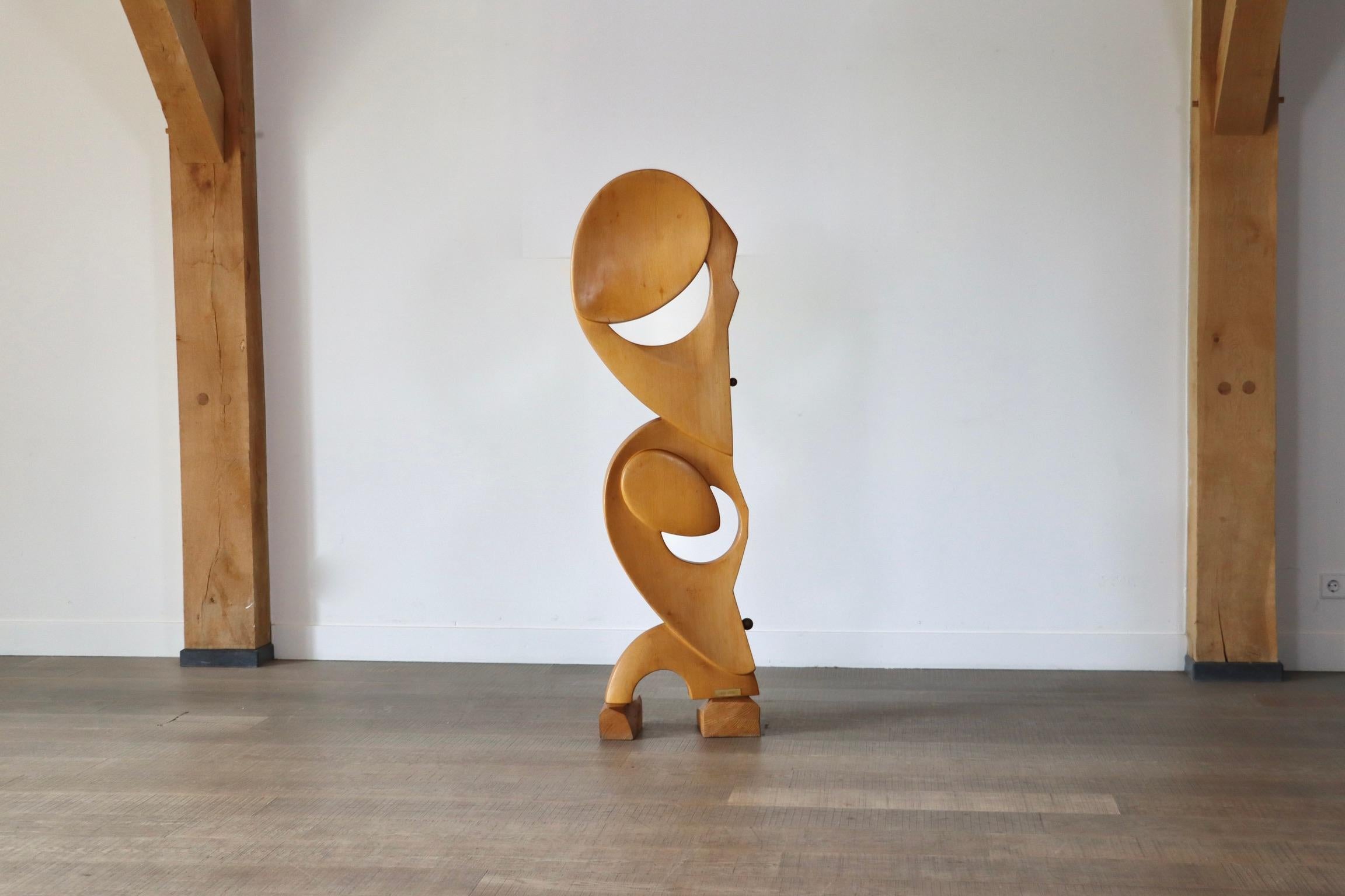 Nice wooden sculpture with brass details carved from Ash wood signed by S. do Lato, Italy 1970s. Its organic shapes are accentuated by two brass round shaped details on the sides, adding an elegant touch to the piece. Crafted from beautiful light