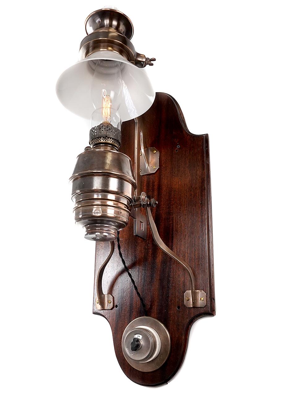 This is one of the more elaborate railcar side lamps you will find. These were larger because they were mostly used over dinning room tables. The interesting outrigger arms were designed hold the lamp straight on the curved wall of a train. 1n the