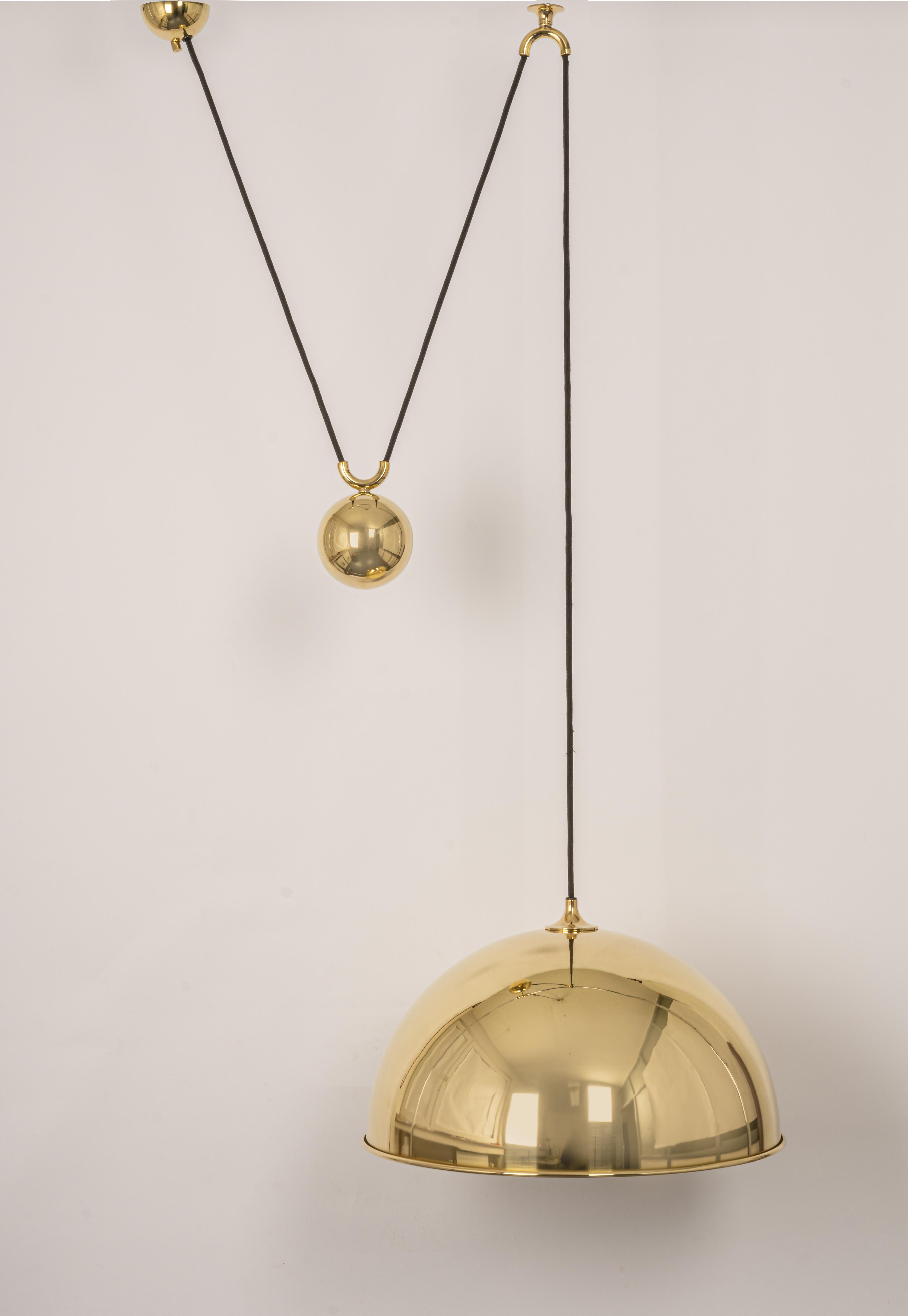 Stunning Posa brass pendant with adjustable counterweight designed by Florian Schulz, Germany, 1970s

One heavy metal ball counter-weight and one brass dome. Cloth cord.
Good vintage condition, with small signs of age and use. Height is