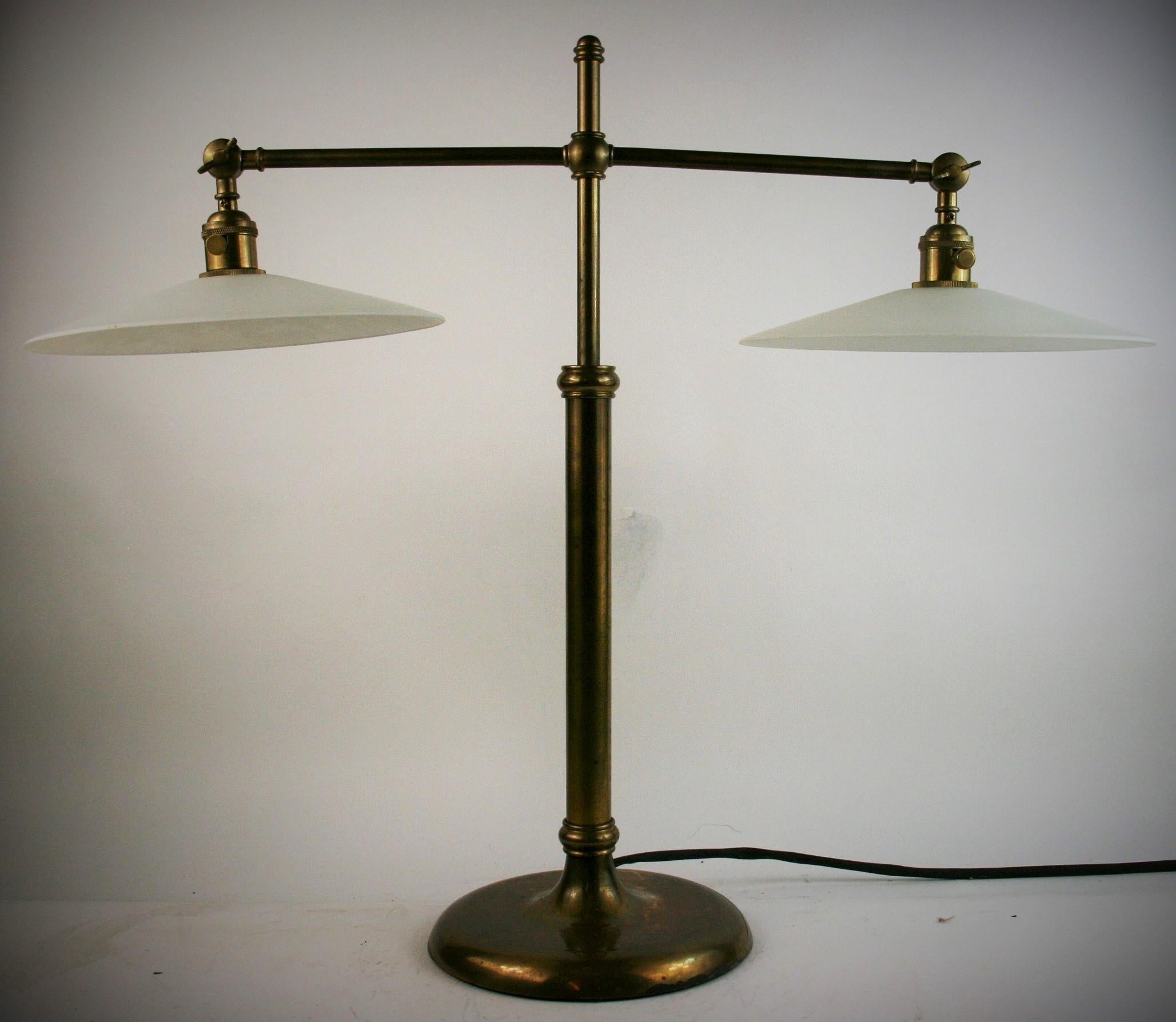 2-345 brass adjustable 2 light table/desk lamp with frosted glass shade'
Each light is adjustable. The center extends from 24