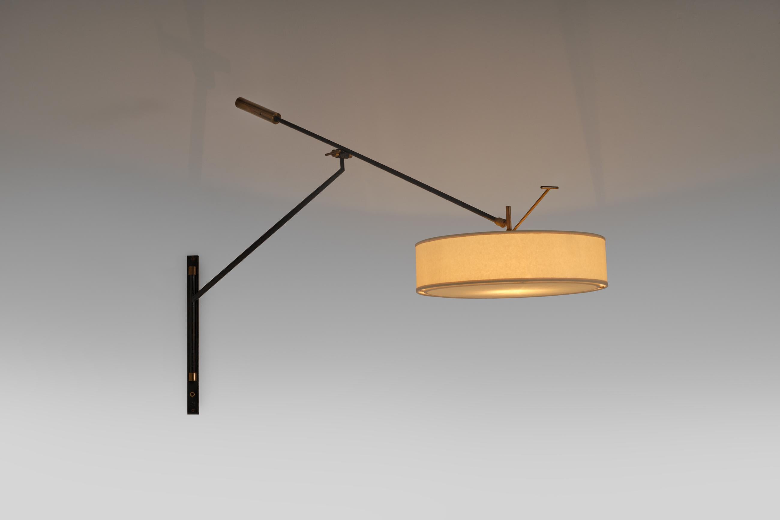 Stunning adjustable wall lamp by Arlus, France 1950s. The frame is constructed out of an anthracite lacquered tubular frame with typical hard French 50's lines, finished with nice refined brass details such as the large counter weight, the hinge