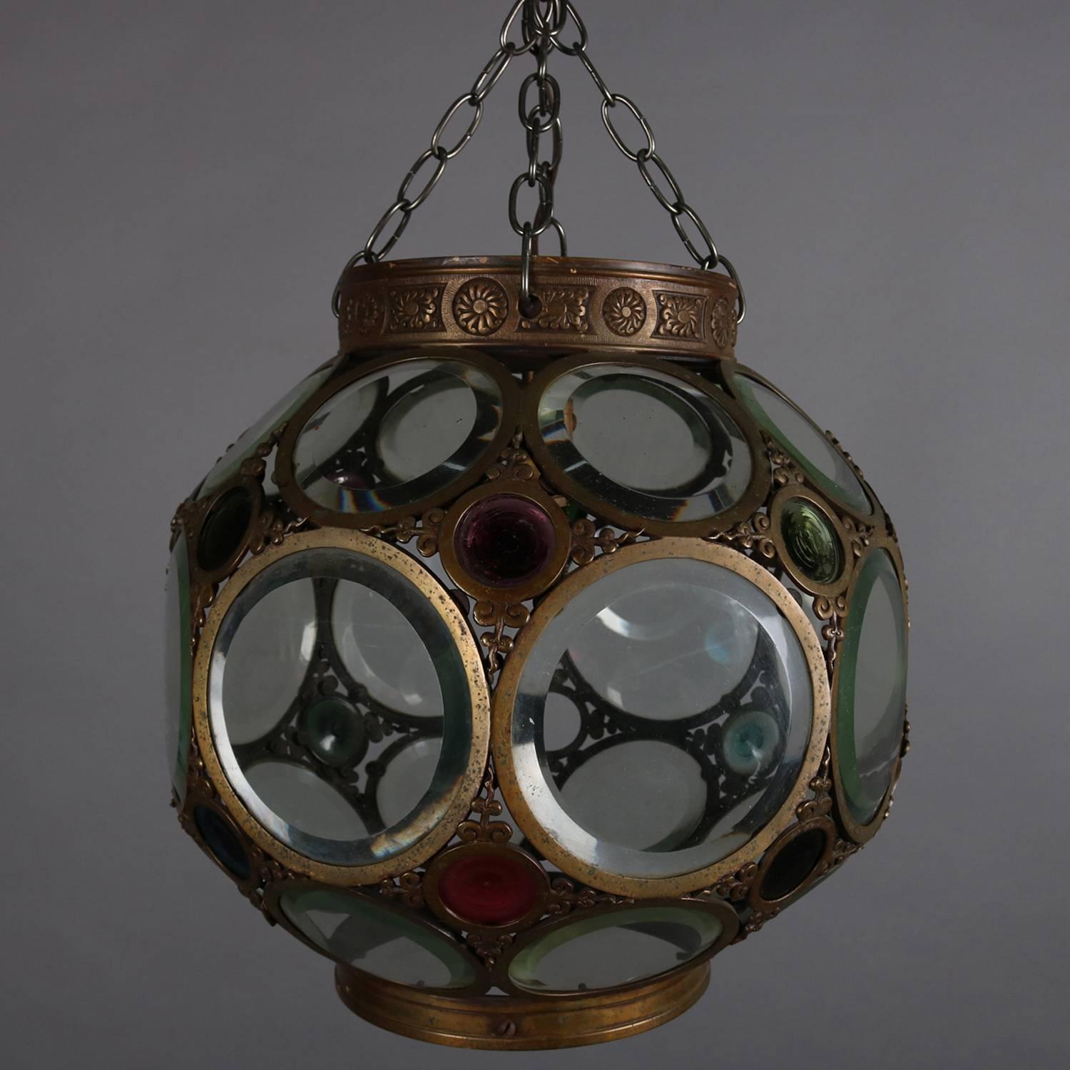 Large and heavy Aesthetic Movement belchers school hanging hall light features bronzed spherical form and pierced frame with insets of beveled and jeweled glass, collar with embossed stylized floral and foliate decoration, elements of Arts & Crafts