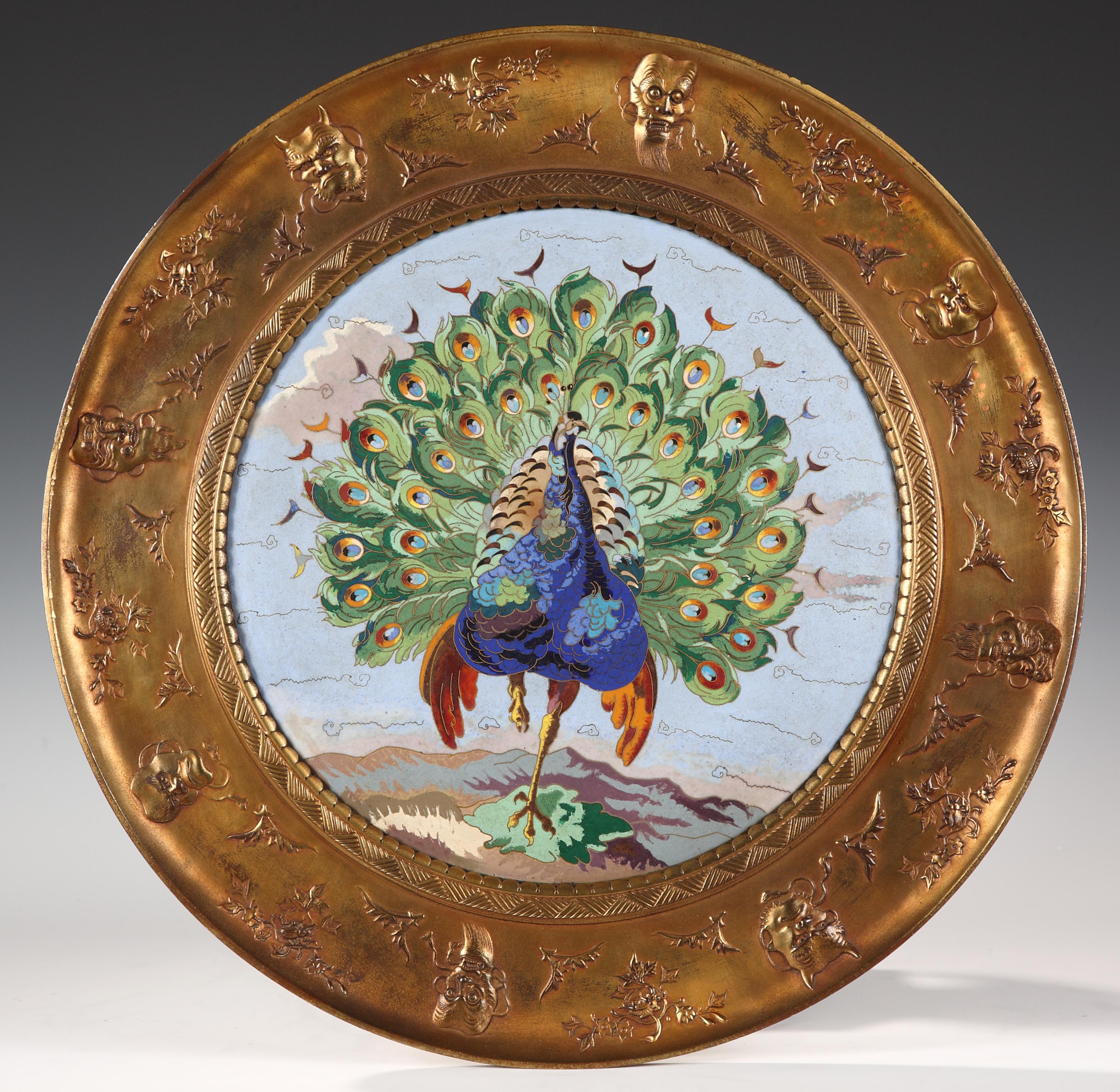 Important tray made in gilded bronze and “cloisonné” enamel attributed to Elkington and Willms. Ornamented with a centering polychrome enameled peacock plaque, made of very high standard quality, mounted on a gilt-bronze dish, decorated in relief