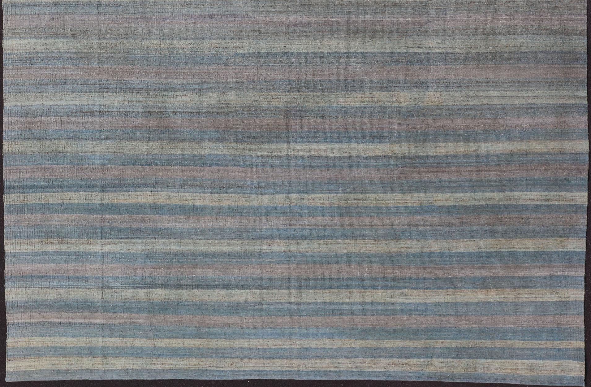 Flat-weave Kilim rug with stripes with modern design in shades of blue, taupe, gray and green, Keivan Woven Arts / rug AFG-87, country of origin / type: Afghanistan / Kilim

This playful piece features a stripe design that evokes casual and easy