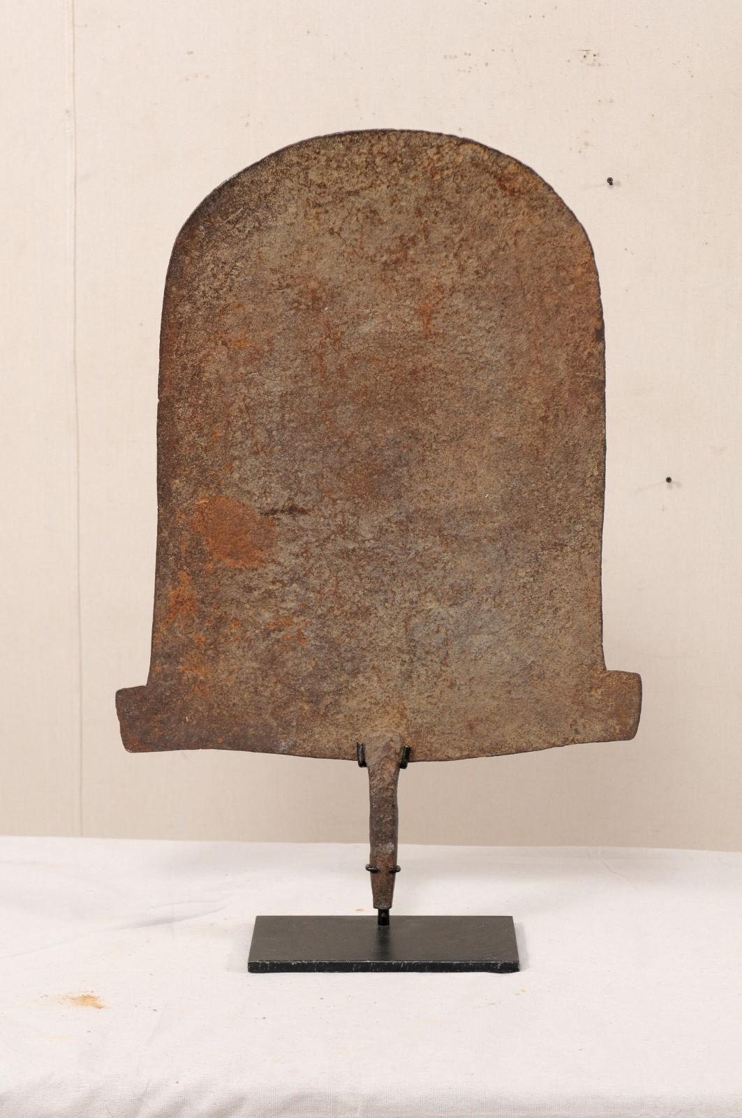 A large specimen of African iron money currency from the early 20th century on custom Stand. This antique iron monetary piece is often referred to as 