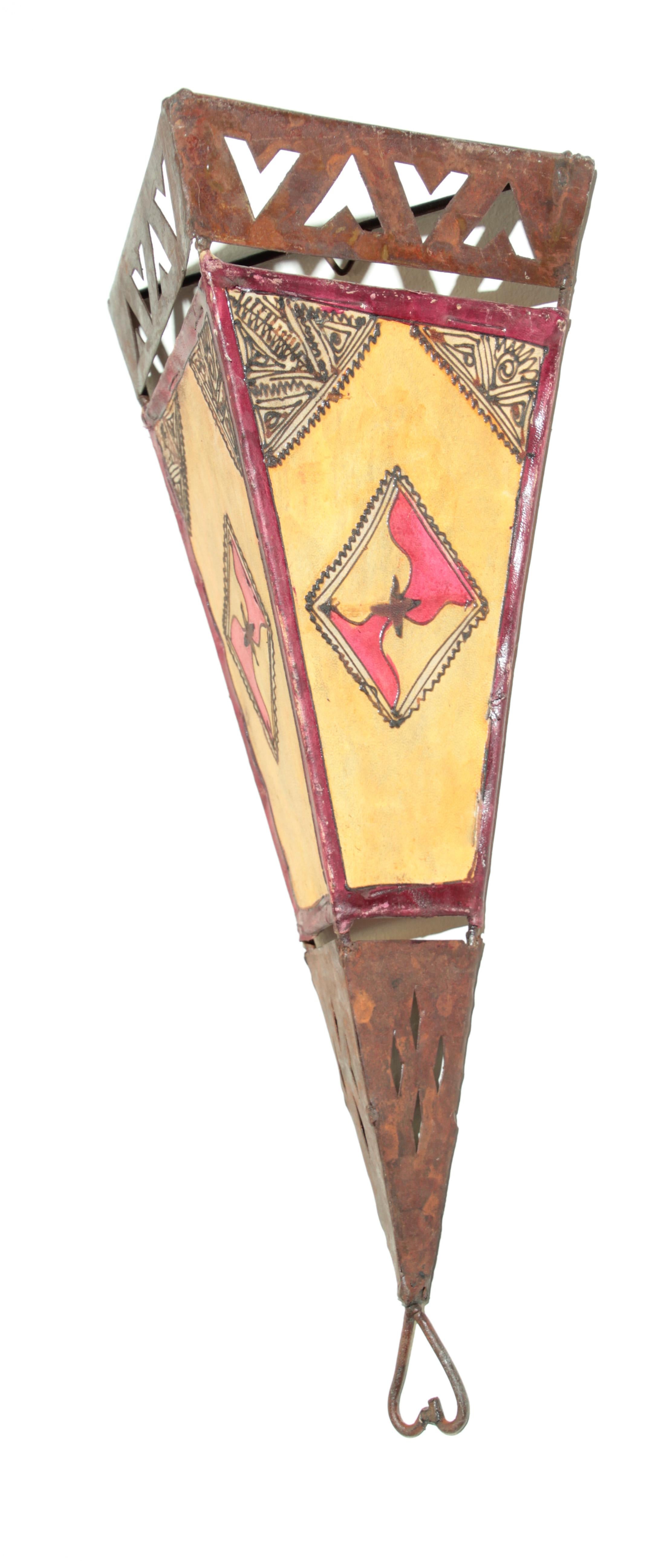 Large African Tribal Art parchment wall shade sconce featuring a large triangle hide form stitched on iron and hand painted surface.
These ethnic Art pieces could be used as wall lamp shade or decorative wall hanging.
Great folk art African Moroccan