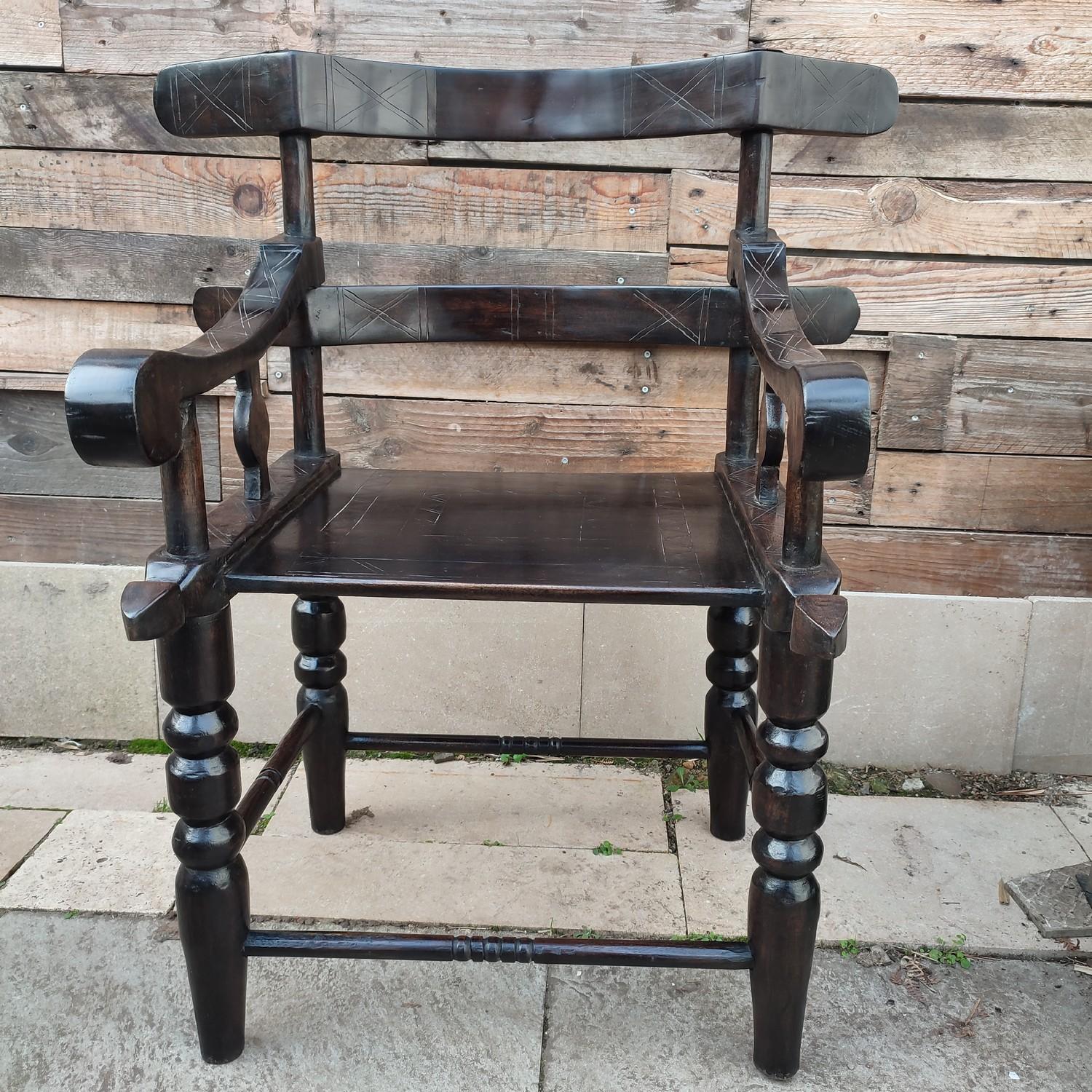 Beautiful hand carved African armchair, with a lovely ebonized finish and patina. It's side 