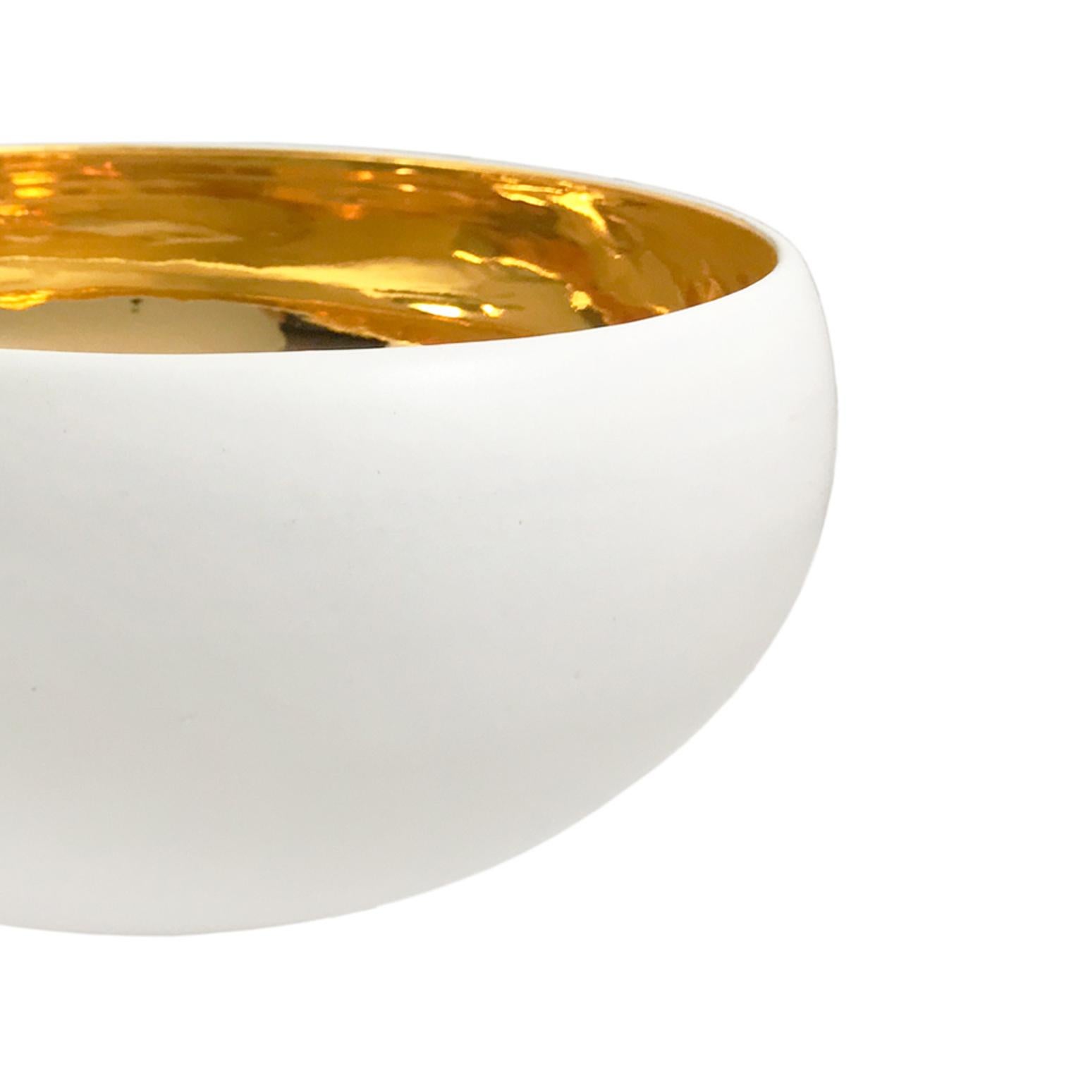 Large alabaster glaze curved ceramic bowl with 22-karat gold lustre interior by Sandi Fellman, 2018. 

Veteran photographer Sandi Fellman's ceramic vessels are an exploration of a new medium. The forms, palettes, and sensuality of her photos can