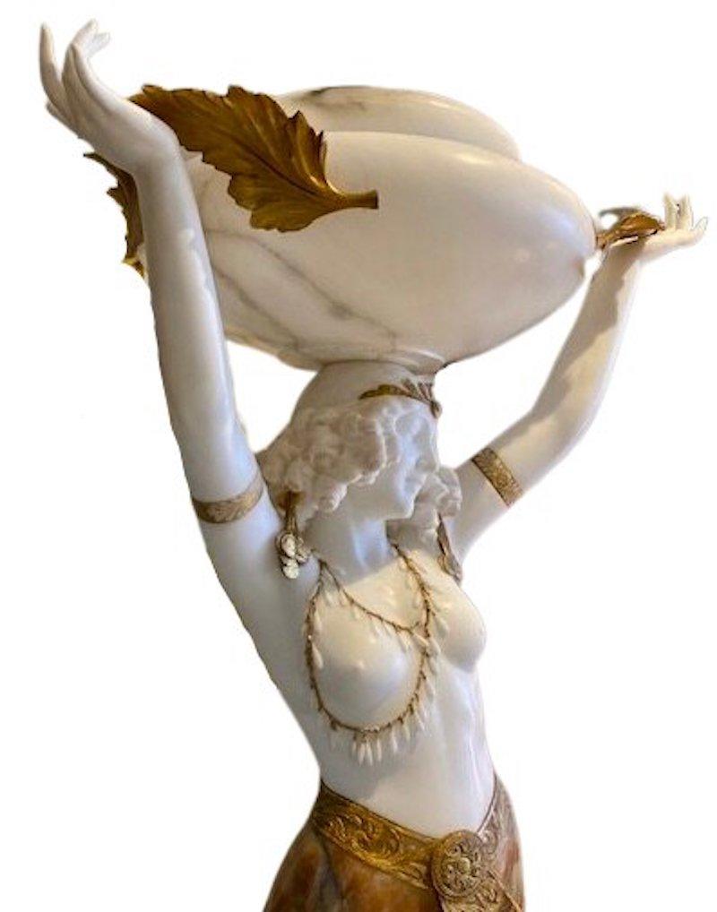 Magnificent large scale Alabaster Female Figure with Light by Giuseppe Gambogi.
A carved and parcel gilt decorated alabaster figure with incorporated light, signed at base near figure's back foot, 'Prof. G. Gambogi, Italy' and also at the skirt hem
