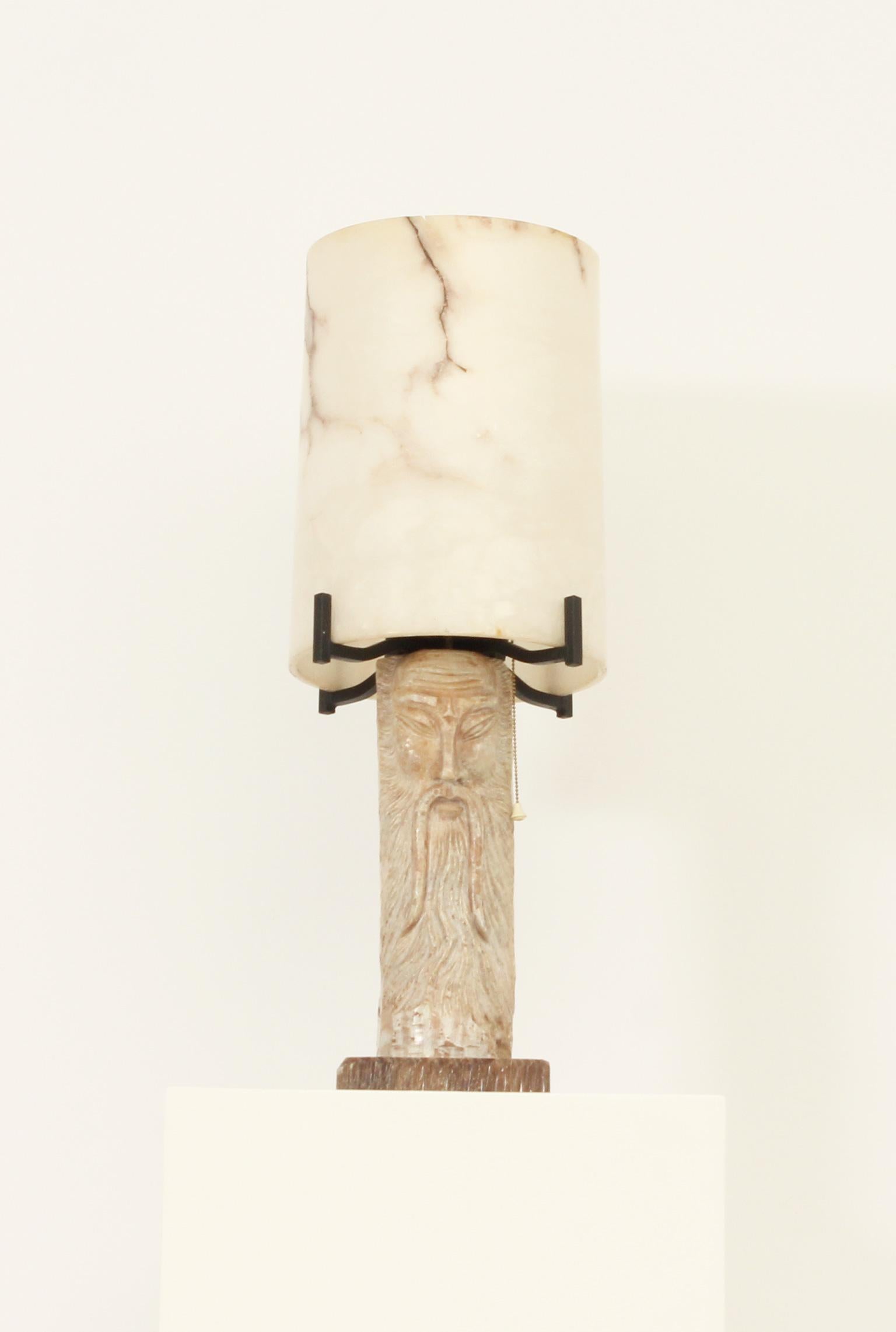 Large alabaster table lamp from 1950's, Spain. Composed of two parts of carved alabaster  and stone base with black forged iron. Interesting lighting effect when the lamp is on.