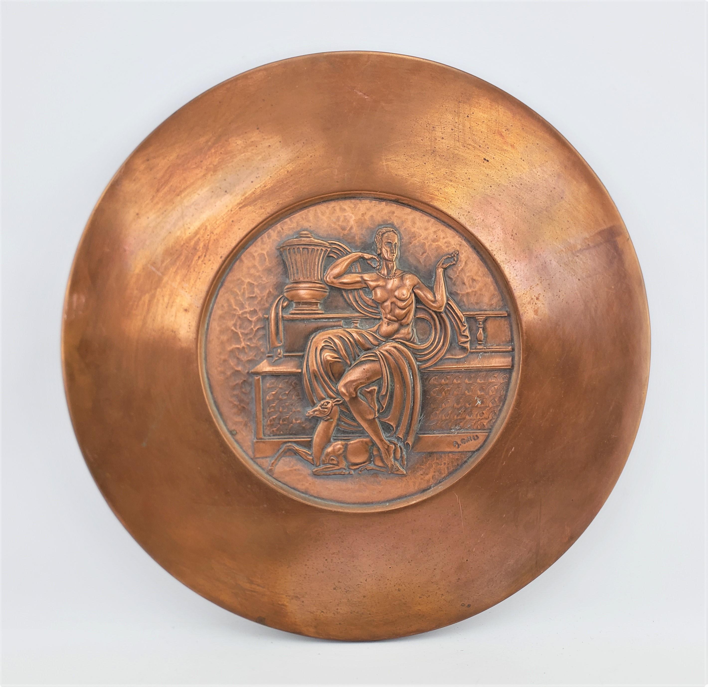 This large copper wall hanging was done by the well known metal worker Albert Gilles from Canada and dates to approximately 1920 and done in an Art Deco style. The round convex wall plaque is done in copper with a repousse disc in the center