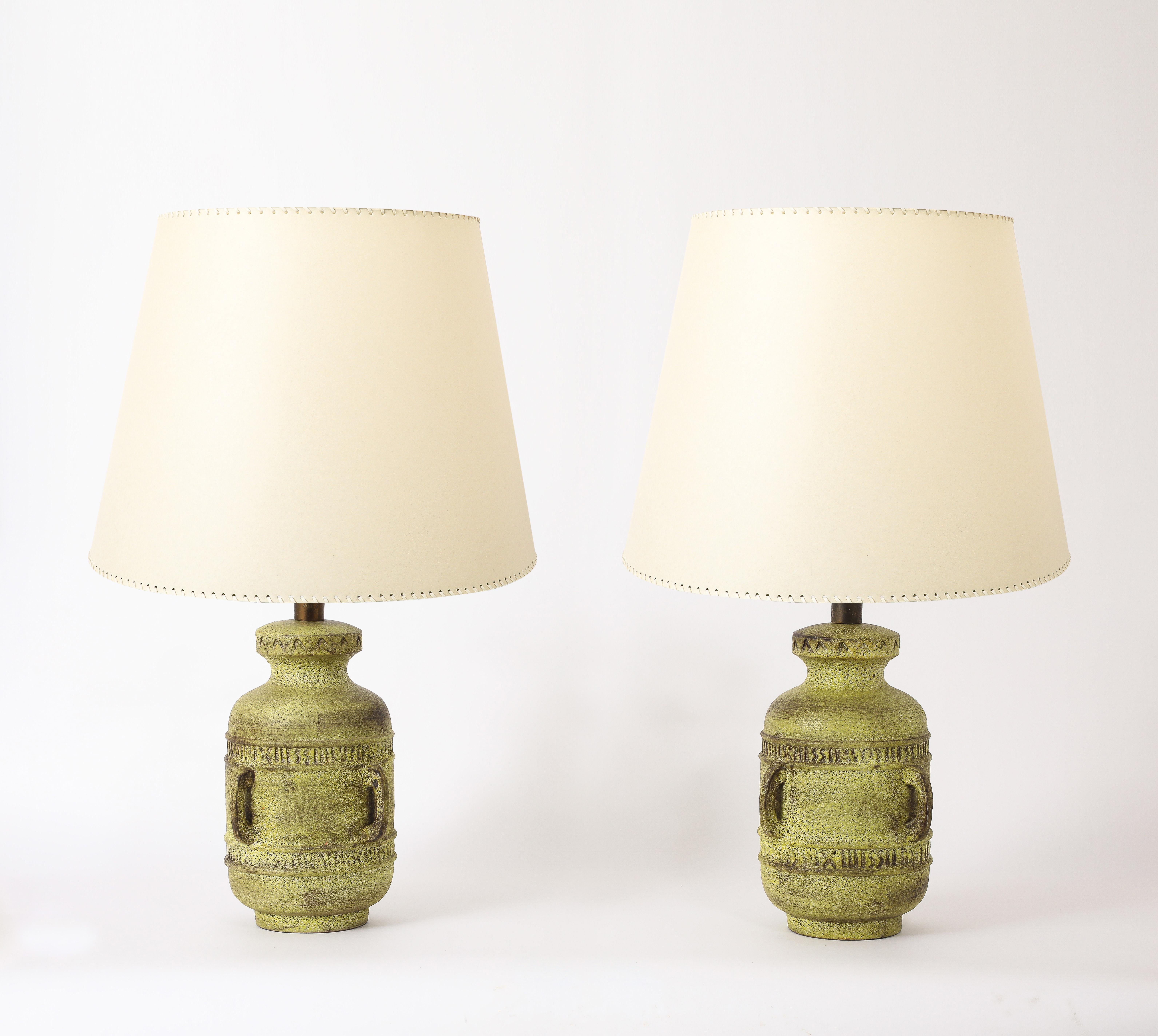 Very large pottery lamps with a scarified motif and short handles in a matte dark yellow glaze.

35x22
Base Only 19x12