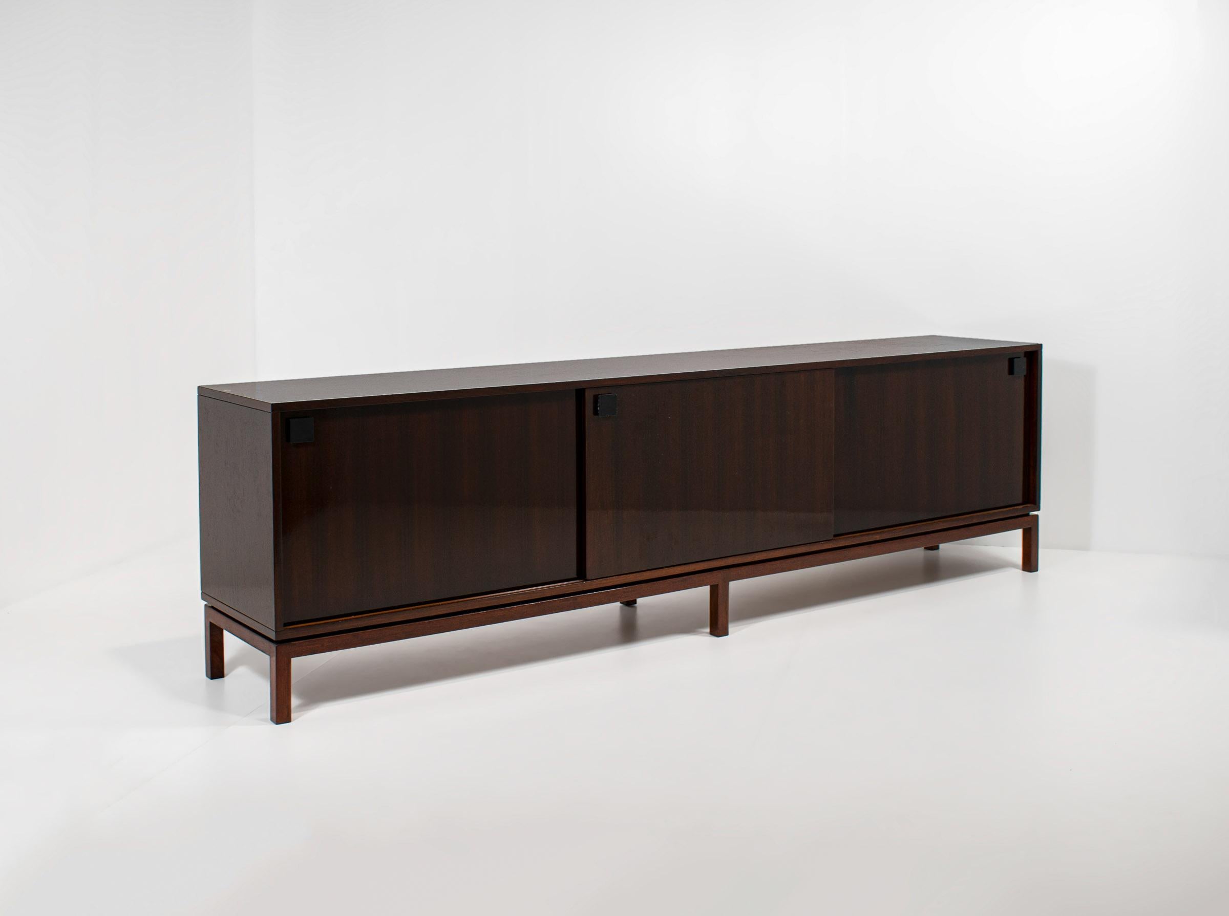 This sideboard has been designed by the Belgian designer Alfred Hendrickx. He was one of the most important post-war designers in the Benelux. His style was minimalistic, but he always kept the bar very high when it came to quality.

This specific