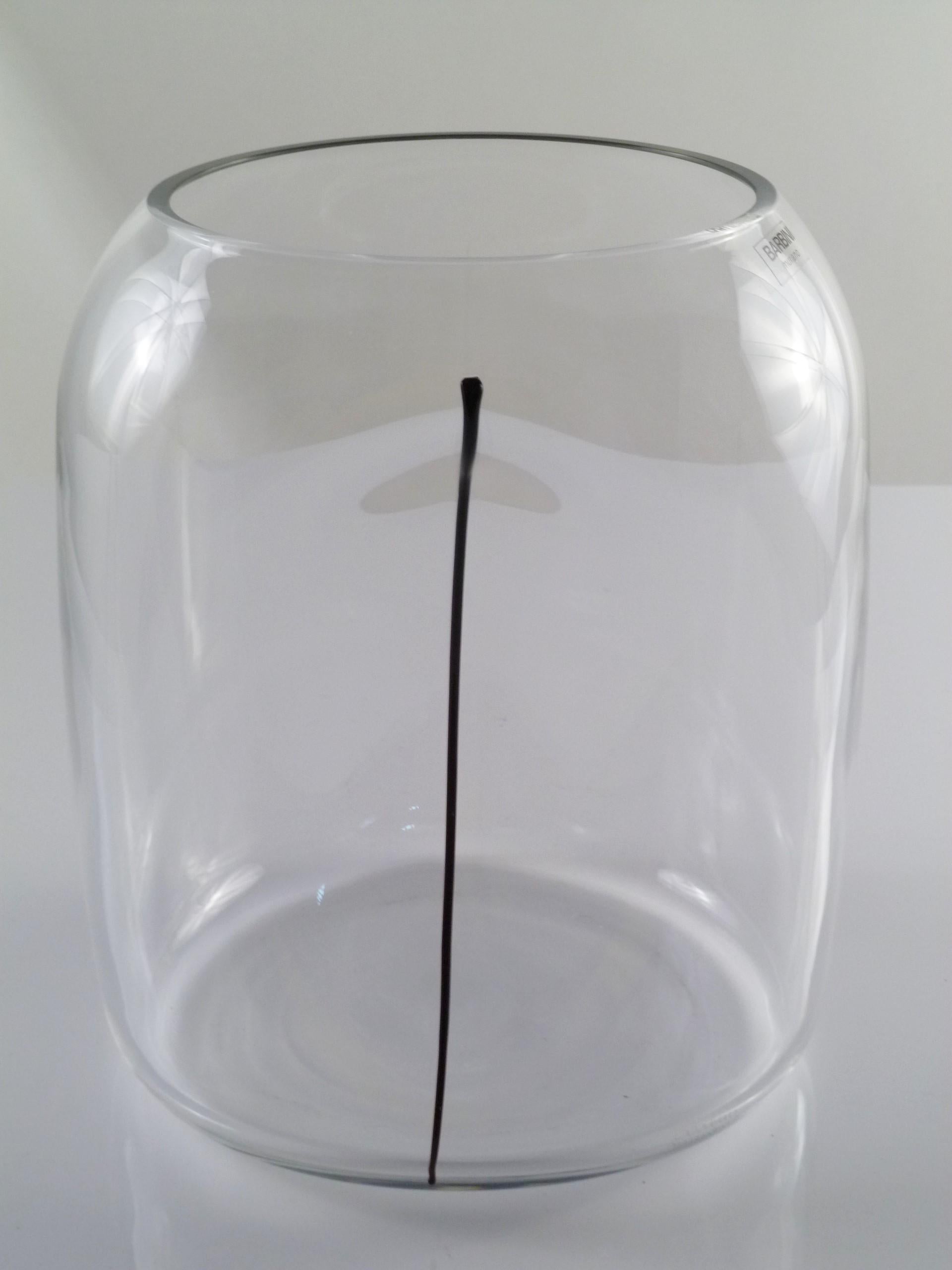 Large and fat, this clear blown glass Alfredo Barbini vase has an Minimalist indented design with an applied black stripe of glass. A quite decorative Murano piece with an etched Barbini Murano signature on a lower side and a Barbini Murano label