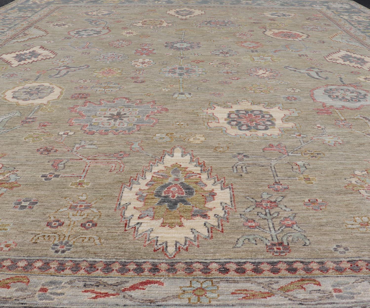 Large All-Over Designed Tabriz with A Yellow-Taupe Background and Muted Colors. Keivan Woven Arts; rug AWR-17599  Country of Origin: Afghanistan Type: Tabriz Circa 2010 Key Words: Floral 
Measures: 10'0 x 13'8 
Tabriz's are known for their