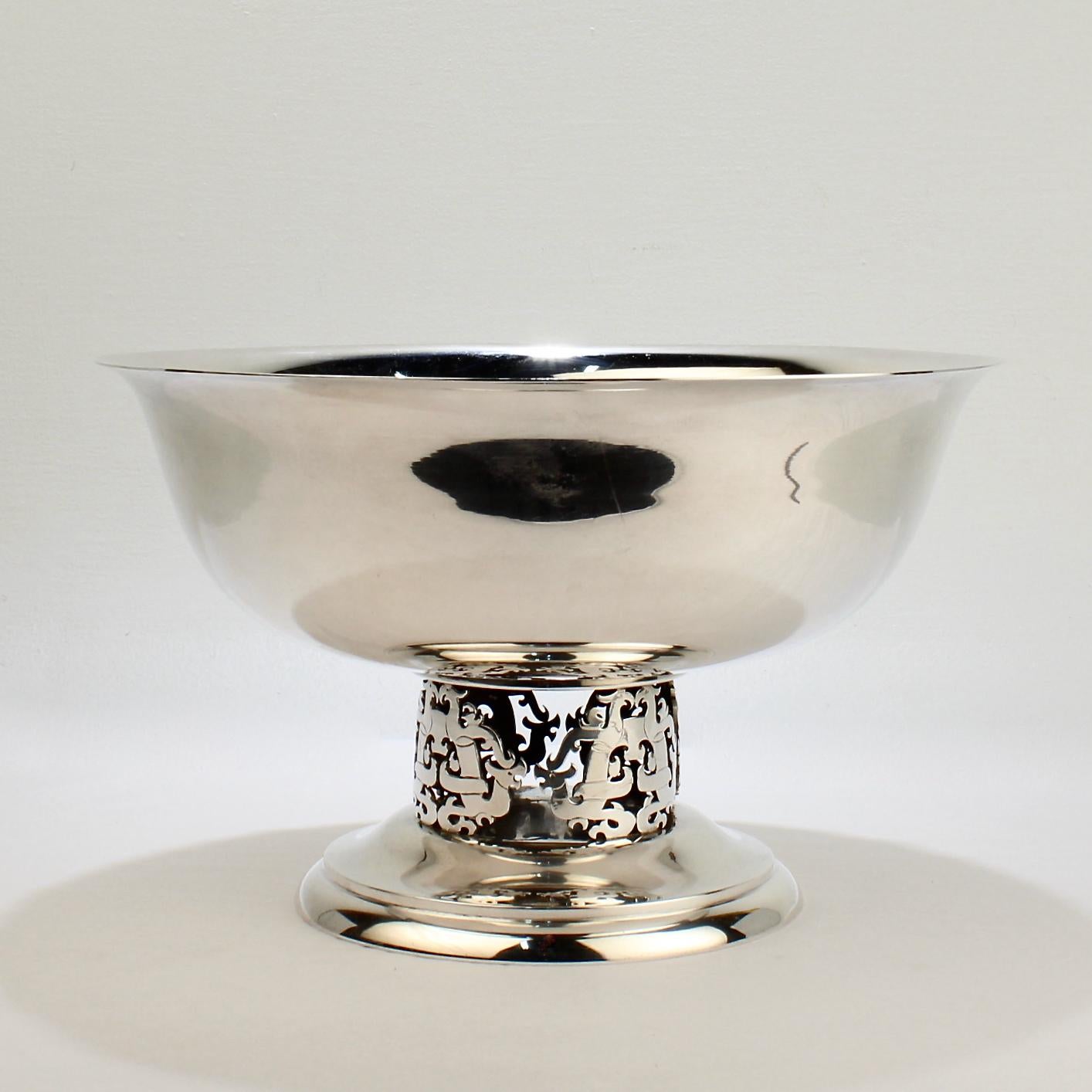 A very fine, large sized punch bowl by Allan Adler. 

The pierced pedestal incorporates Chinese iconography with dragons and stylized phoenixes. 

The mid-century design is perfect for a stylish Hollywood Regency or (any Mid-Century Modern) room