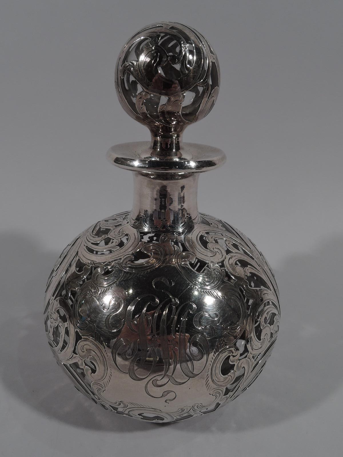 Large turn-of-the-century Art Nouveau glass cologne bottle with engraved silver overlay. Made by Alvin in Providence. Globular; short neck and everted rim in collar. Ball stopper. Dense and leafing rinceaux overlay. Large scrolled cartouche engraved