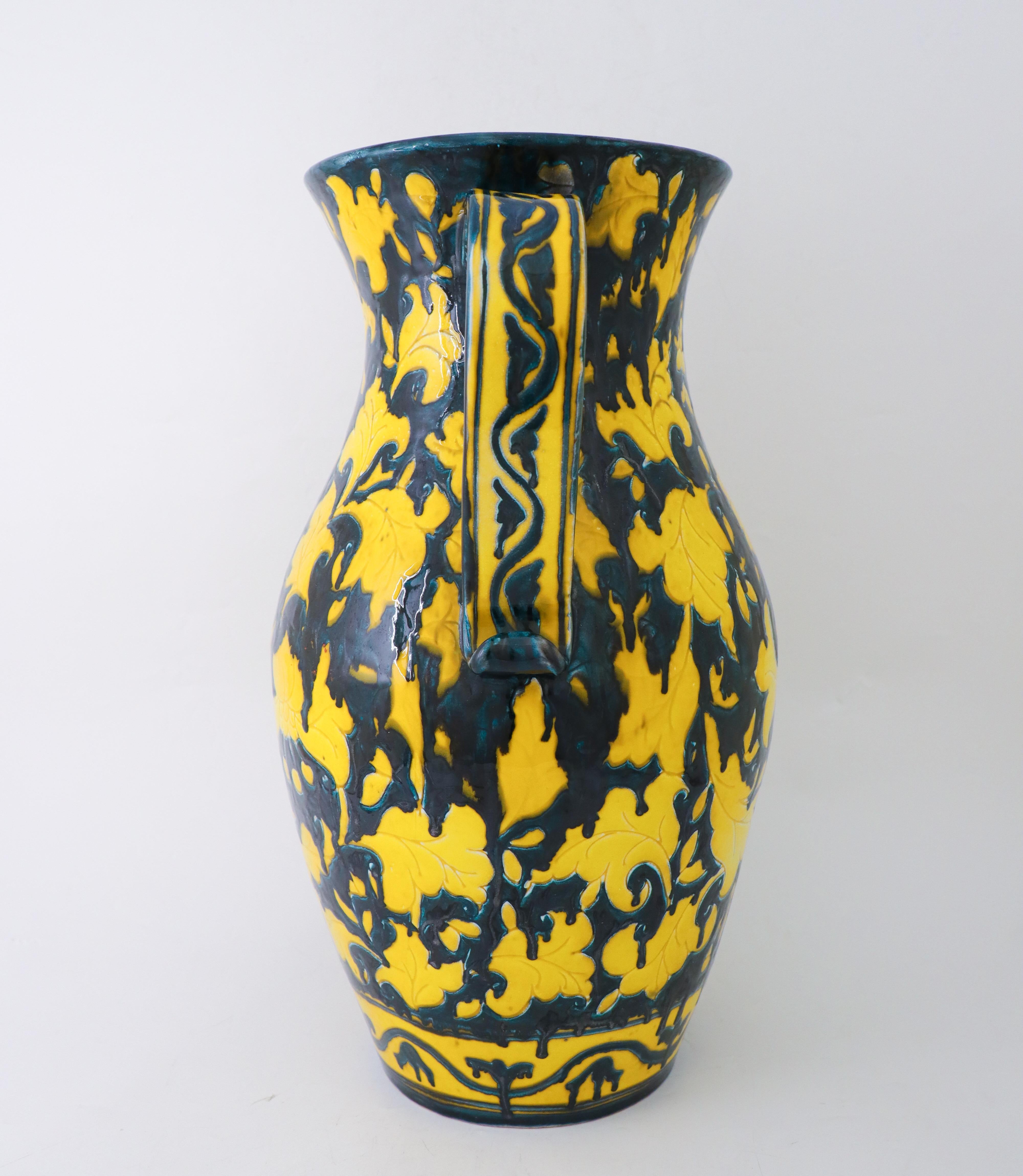 A lovely yellow and dark green jug in ceramic from Italy. It is 48 cm (19.2