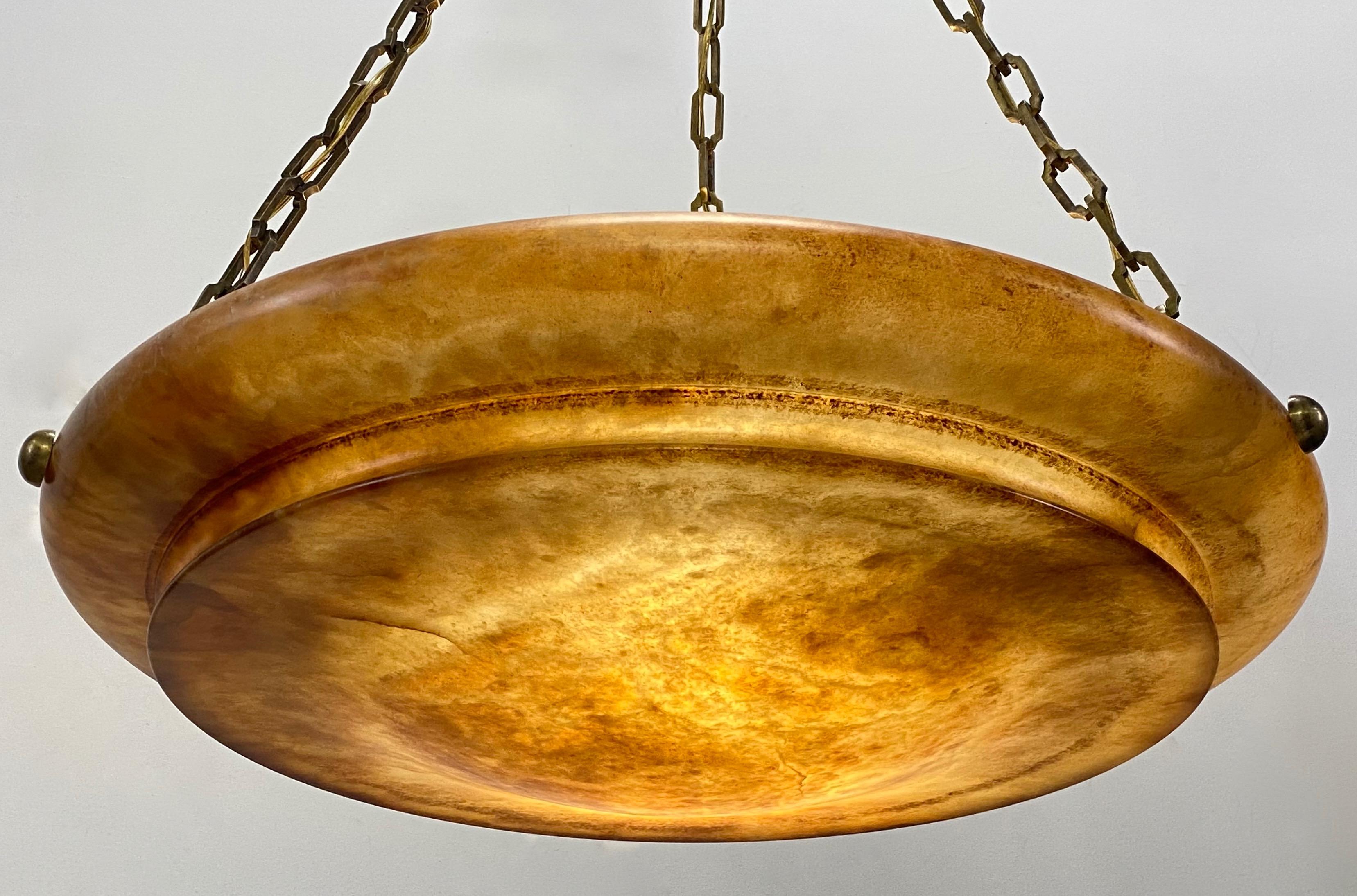 An impressive large scale amber color alabaster bowl shape light fixture with antique solid bronze square link chain and canopy.
Newly reconditioned and re-wired.

Measurement of the bowl is 7 inches high x 29 inches diameter.