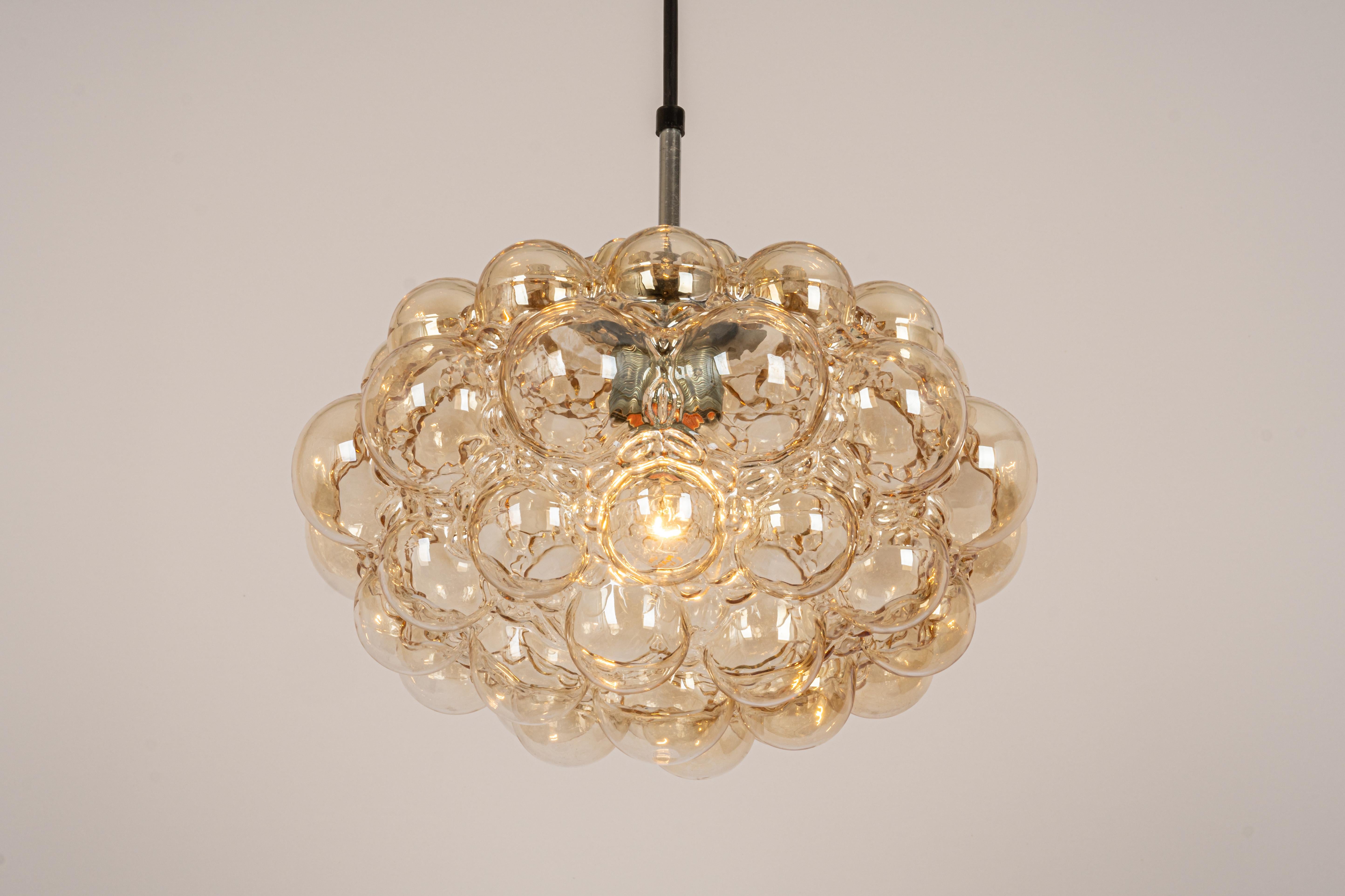 A large round with light smoke tone bubble glass pendant designed by Helena Tynell for Limburg, manufactured in Germany, circa 1970s

Sockets: It needs 1 x E27 standard bulb.
Light bulbs are not included. It is possible to install this fixture in