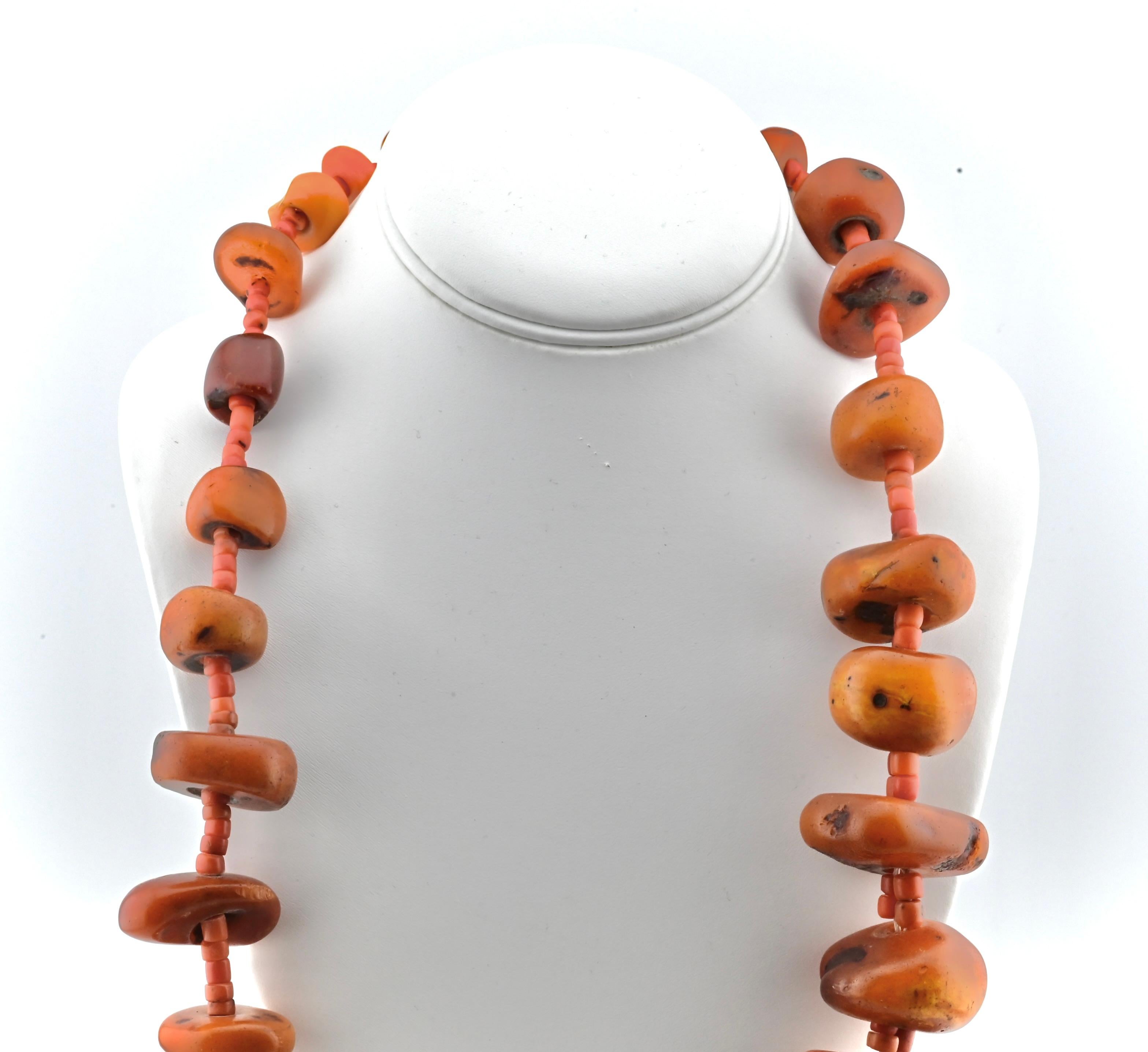 This is a beautiful separated authentic amber beaded necklace. Each amber chunk has been lightly tumbled with fine natural coral imbedded and the necklace weighs a total of 270 grams. It’s 31 inches in full length, and it’s in fair condition with