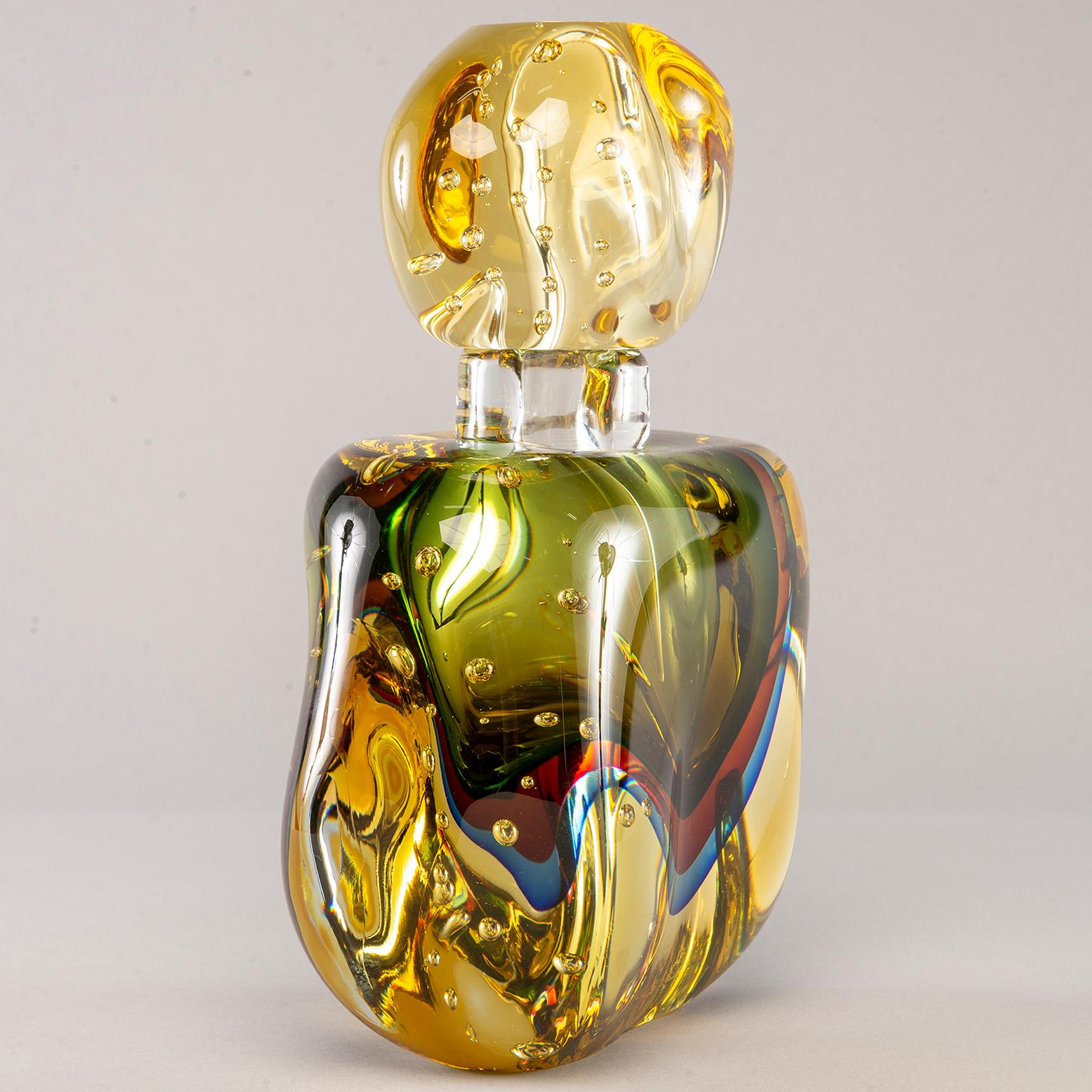New handmade oversized Murano glass perfume bottle. Thick amber colored glass with Sommerso style layers of magenta, blue and green glass. Large stopper.