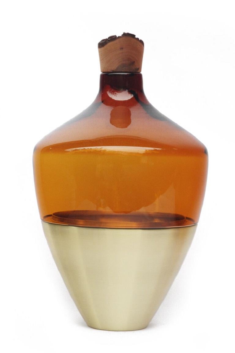 Large Amber India vessel II, Pia Wüstenberg
Dimensions: D 30 x H 55.
Materials: glass, wood, metal.
Available in other metals: brass, copper.

Handmade in Europe, by individual craftsmen: handblown glass (Czech Republic), hand spun metal,