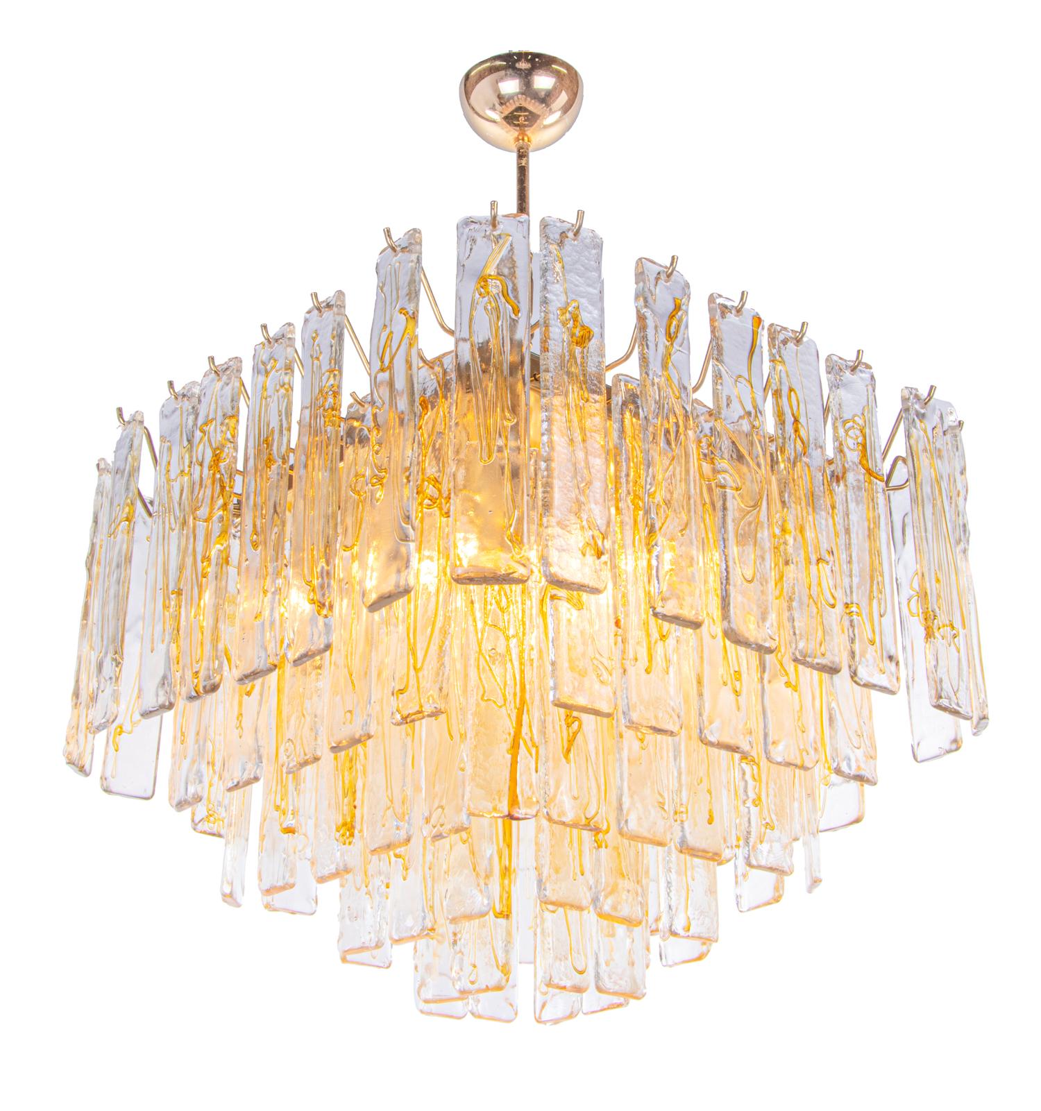 Elegant large Murano lava glass chandelier with hand blown amber textured glass panels on a gold plated brass frame. The chandelier illuminates beautifully. Gem from the time. With this light you make a clear statement in your interior design. A