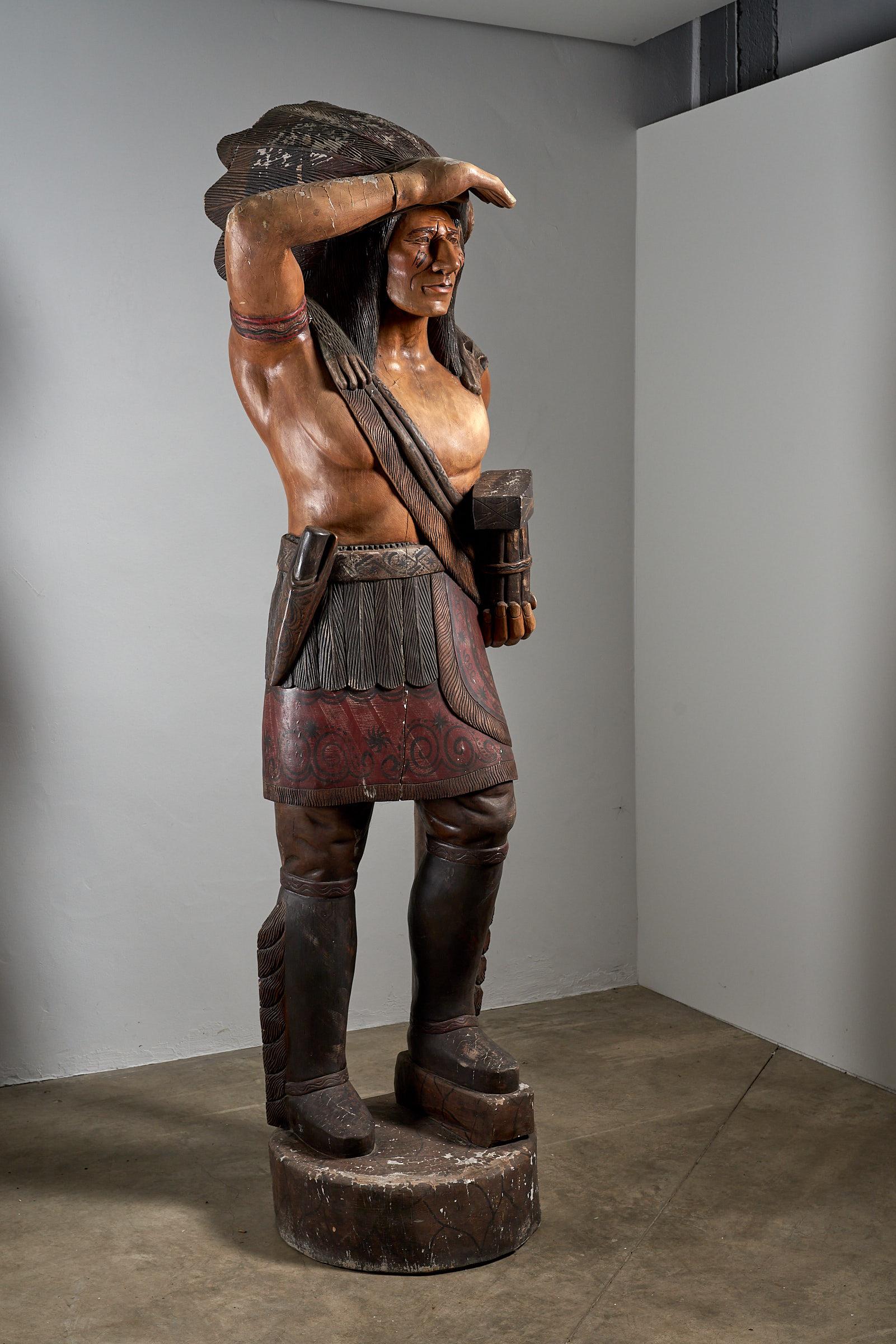 Imposing and Iconic: Large American Carved Cigar Store Indian Chief, Standing at 2.4 Meters Tall. This magnificent sculpture, historically used to promote tobacco, encapsulates the rich heritage of American craftsmanship. The intricate carvings