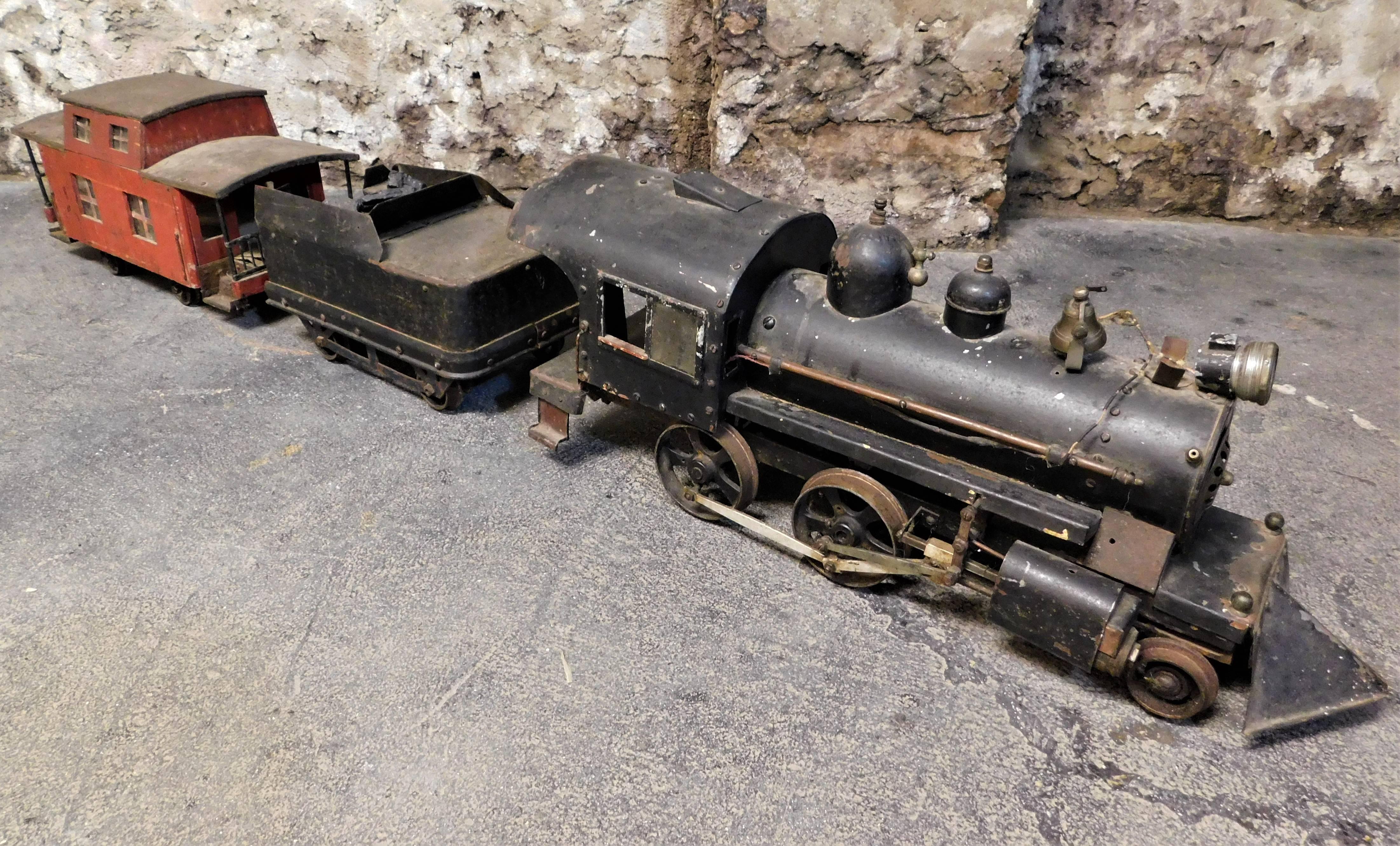 This large American Folk Art metal train with a locomotive engine which measures 30.5 inches long, coal car which measures 14 inches long and caboose 22 inches long.