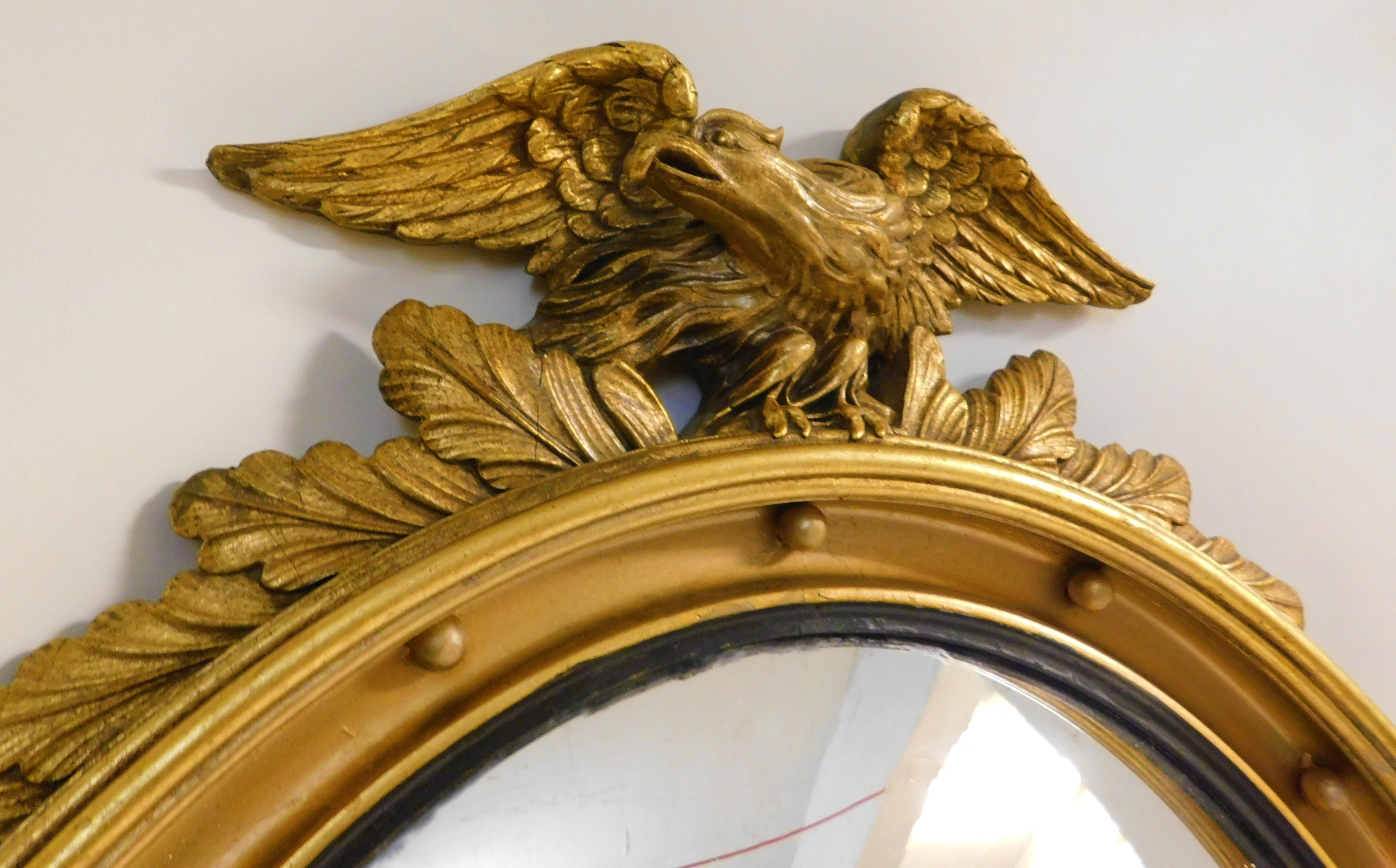 Victorian Large American Gilt Carved Wood Eagle Oval Convex Wall Mirror, circa 1890 For Sale