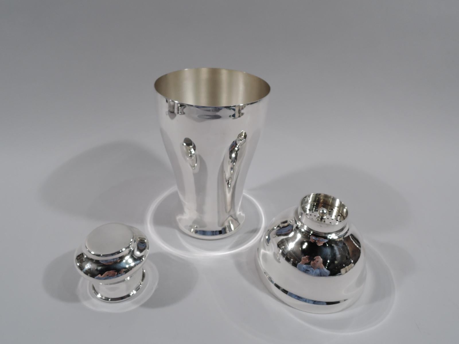 American Modern sterling silver cocktail shaker, circa 1920. Curved and tapering bowl, domed top, and short neck with built-in strainer and bellied snug-fitting cap. Large and voluptuous form. A two-handed model. Marked “Sterling / 2238”. Weight: 15