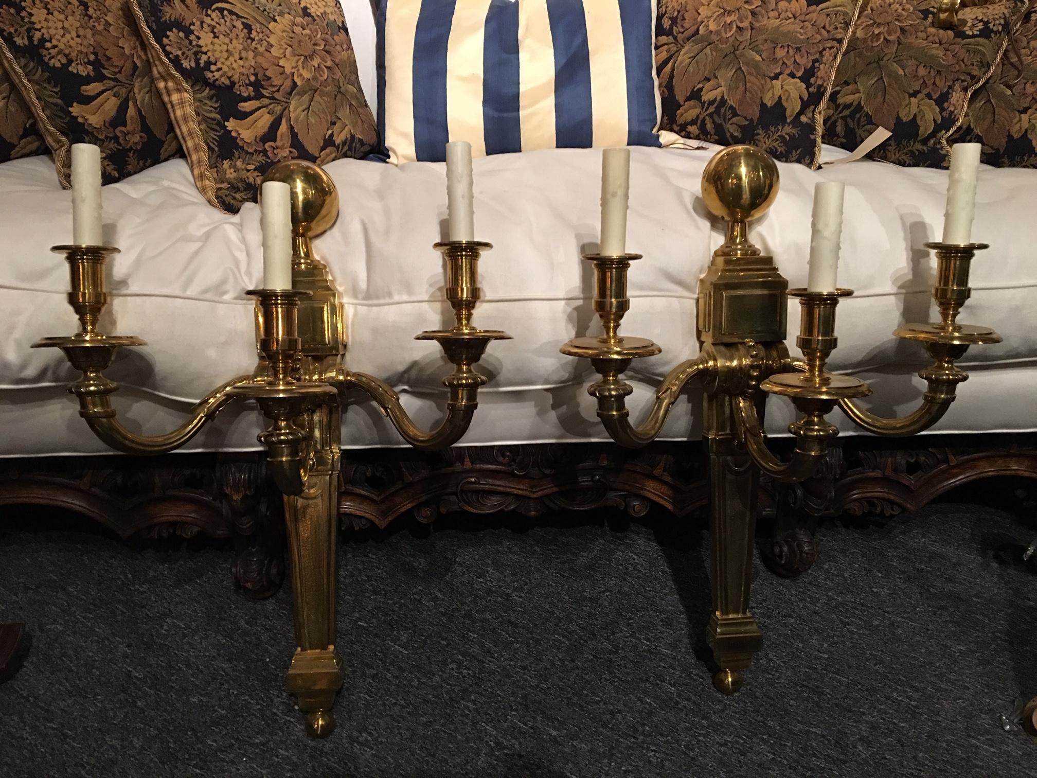 Large American polished brass three-light American sconces, early 20th century.