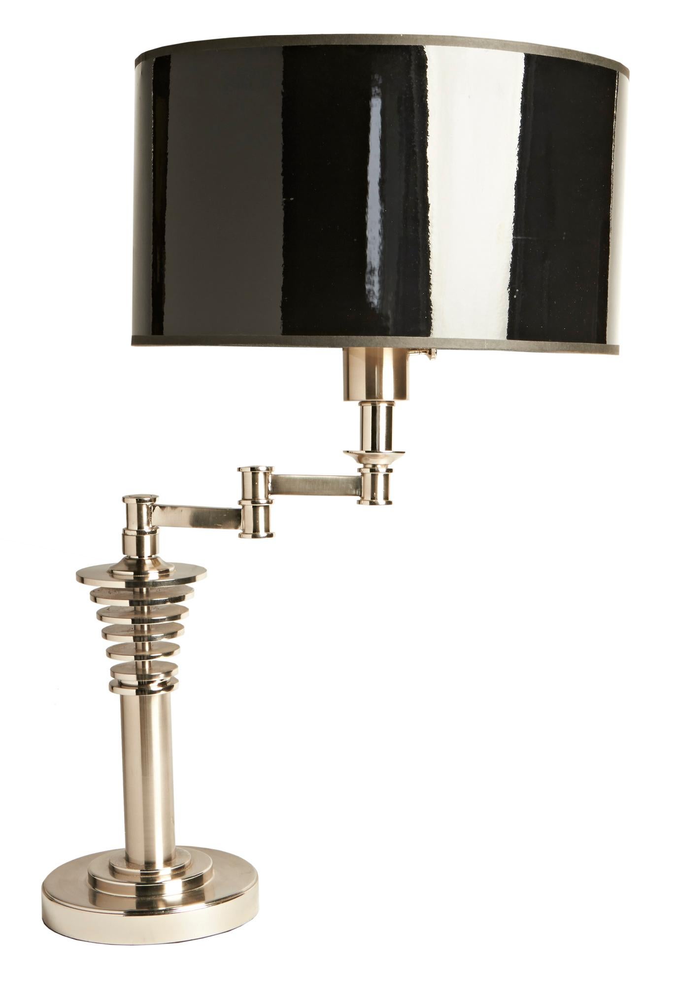 This impressive American Postmodern swing arm desk lamp has all the design features of the Machine Age but with a modern twist. It is executed in brushed steel and polished chrome and is in near mint condition. ( The contemporary shade shown is for