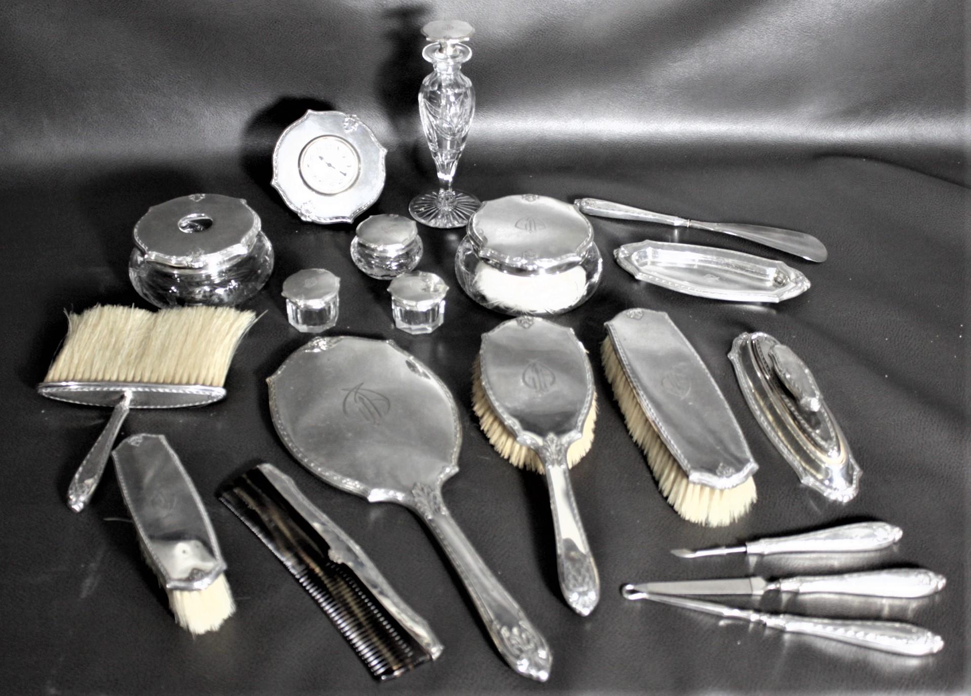 This very large sterling silver ladies dresser or vanity set was made in the United States, in approximately 1920 in the period Art Deco style. The set is composed of at least nineteen pieces, more if every single piece is counted, and includes the