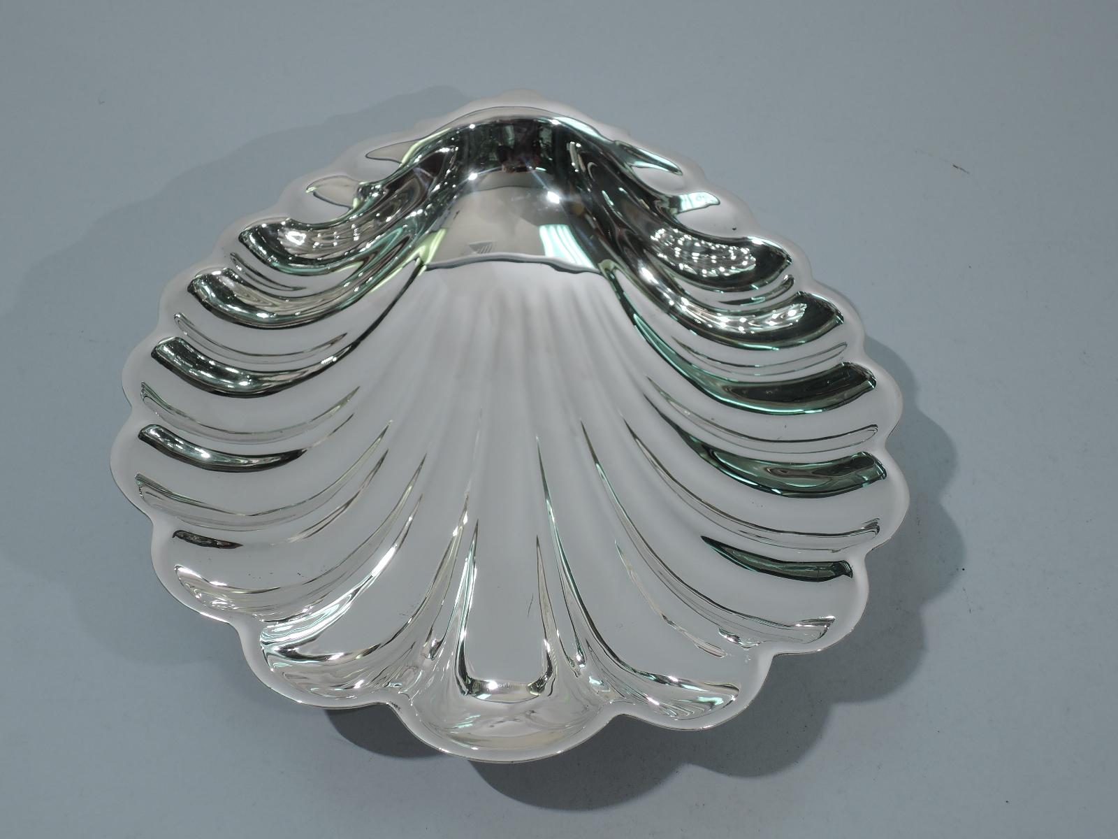 Large sterling silver scallop shell bowl. Made by Gorham in Providence in 1941. Elongated form and dynamic flutes. Rests on 2 balls. Fully marked including date code and no. 42606. Weight: 11 troy ounces.