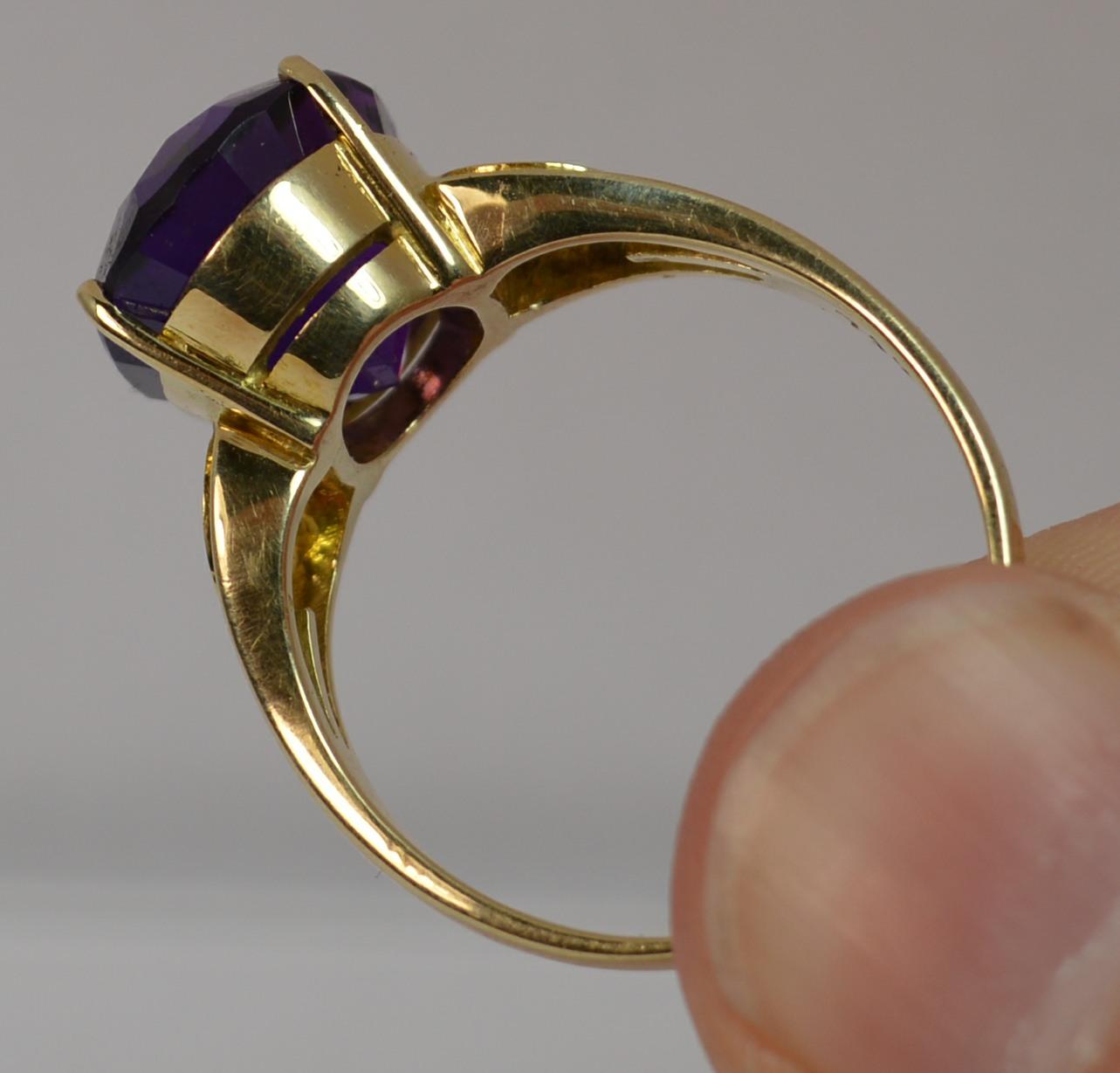 
A stunning 14ct Gold, Amethyst and Diamond ring.

Large oval cut amethyst to measure 11mm x 13.8mm with a natural diamond to each side. Protrudes 8mm off the finger.

Beautifully deep purple colour to the amethyst.

Modelled in a solid and