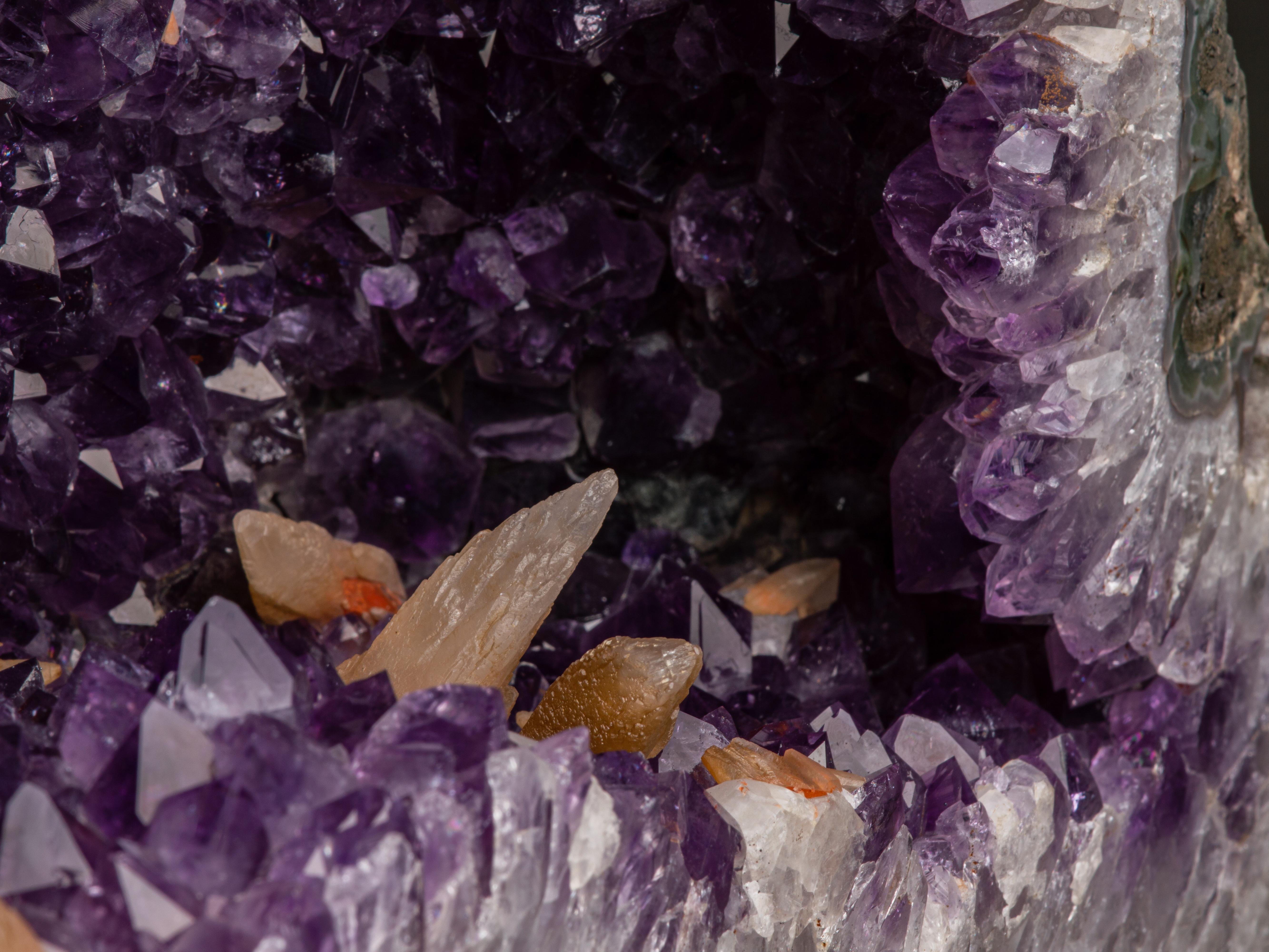 Another large amethyst chapel, the corresponding half of the original geode,
showing deep purple amethyst crystals punctuated with small stalactites
and overlaid in places with tan coloured druzy quartz. The thick
white quartz borders lie inside a