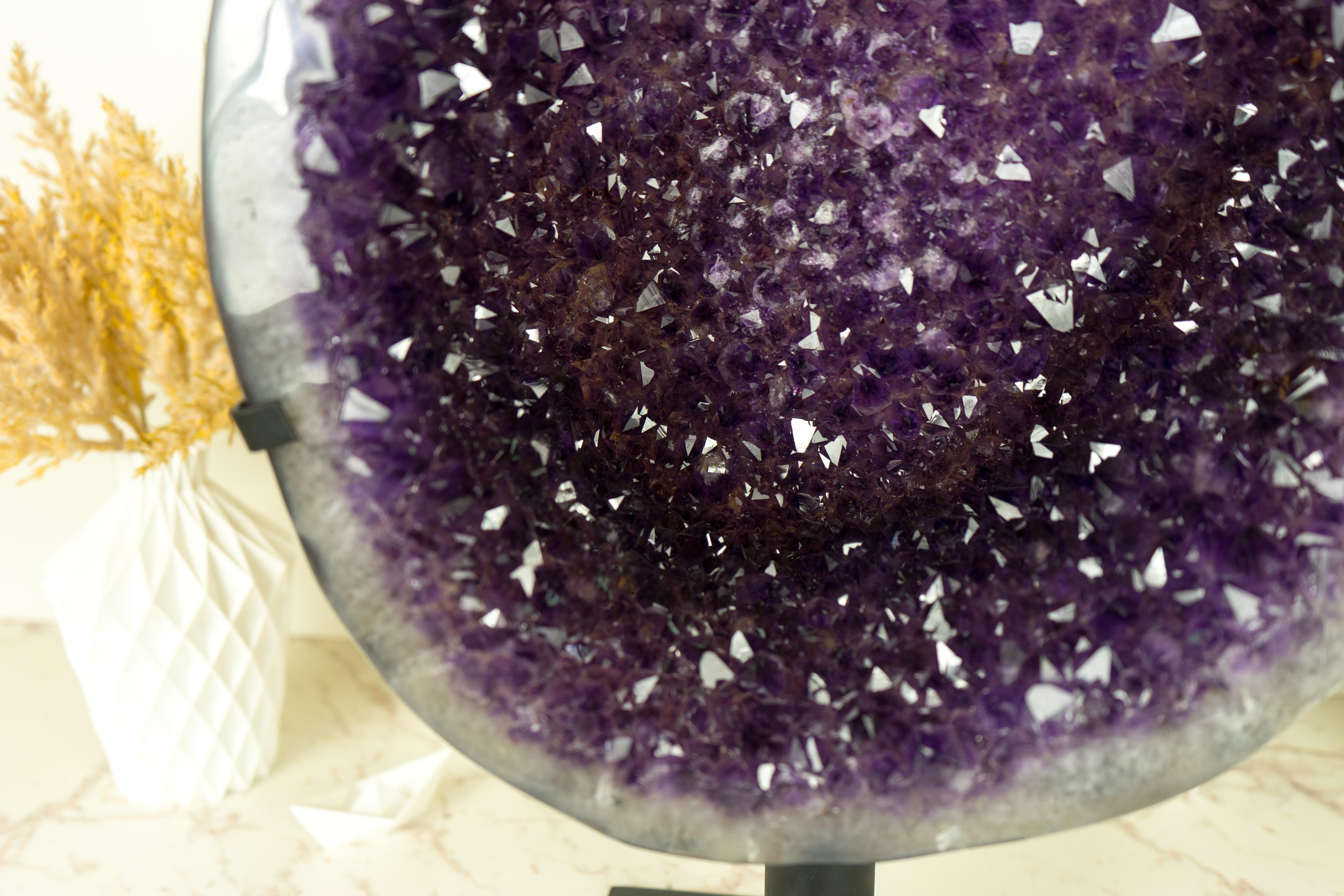 An Amethyst Geode Cluster that is a natural work of art, where Galaxy Amethyst Druzy shines as a celestial night and contrasts beautifully with the serene polished agate, creating a one-of-a-kind Amethyst of unparalleled uniqueness. A specimen that