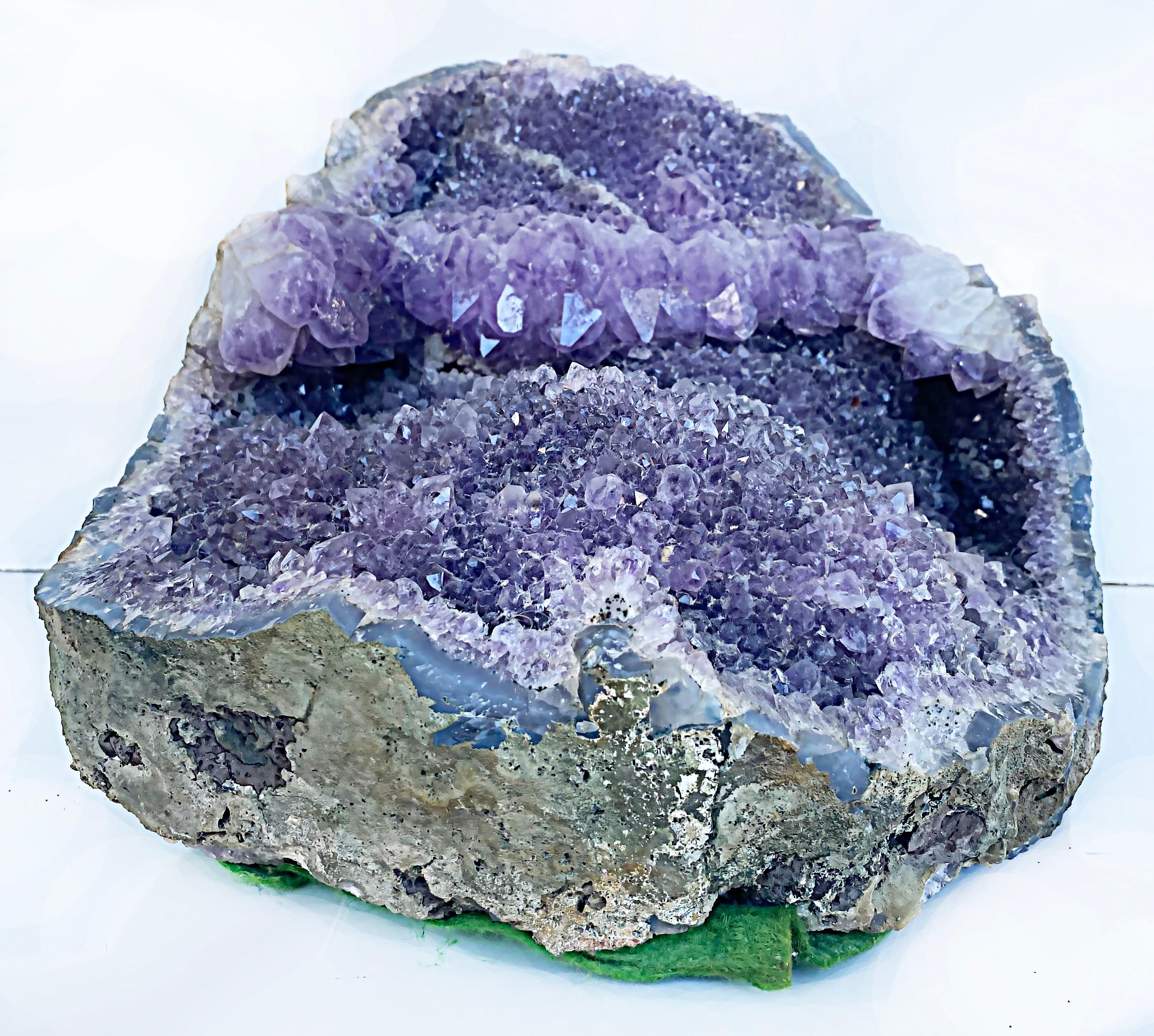 Large Amethyst Quartz crystal geode mineral specimen cluster.

Offered for sale is a naturally formed large amethyst crystal geode that has been nicely opened with an almost 3/4 full formed.

Dimensions: Height: 9.5 in (24.13 cm)
Width: 14 in (35.56