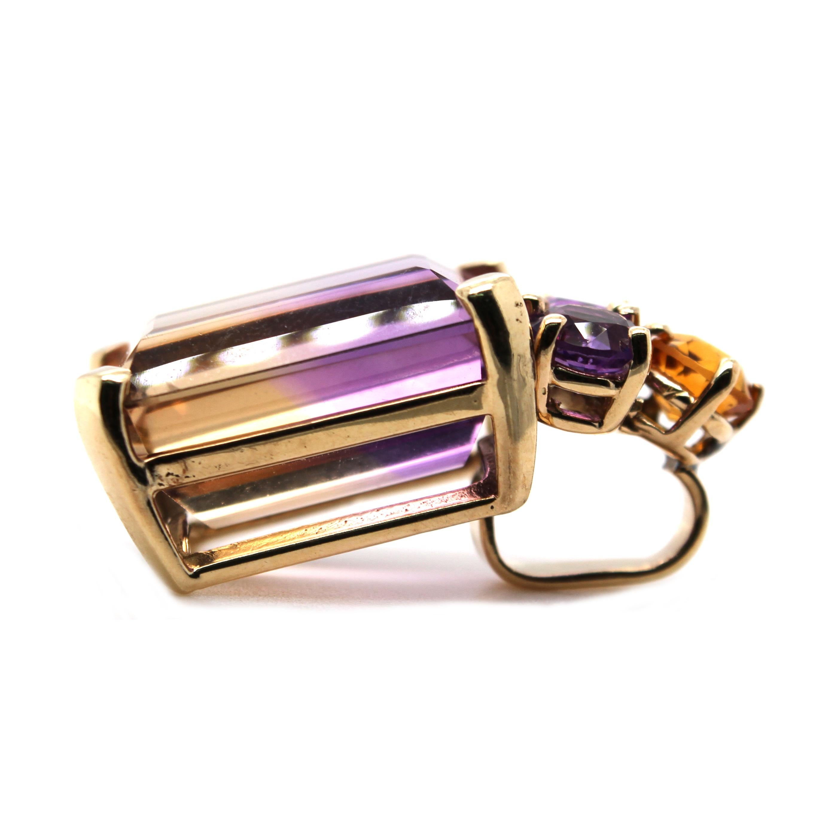 14 Karat Yellow Gold Slide Pendant Featuring an Emerald Cut Ametrine Measuring 18mm x 13mm Weighing Approximately 15 Carats Accented by 2 Round Amethysts and 1 Round Citrine. 1 Inch Long. Finished Weight is 9.0 Grams.