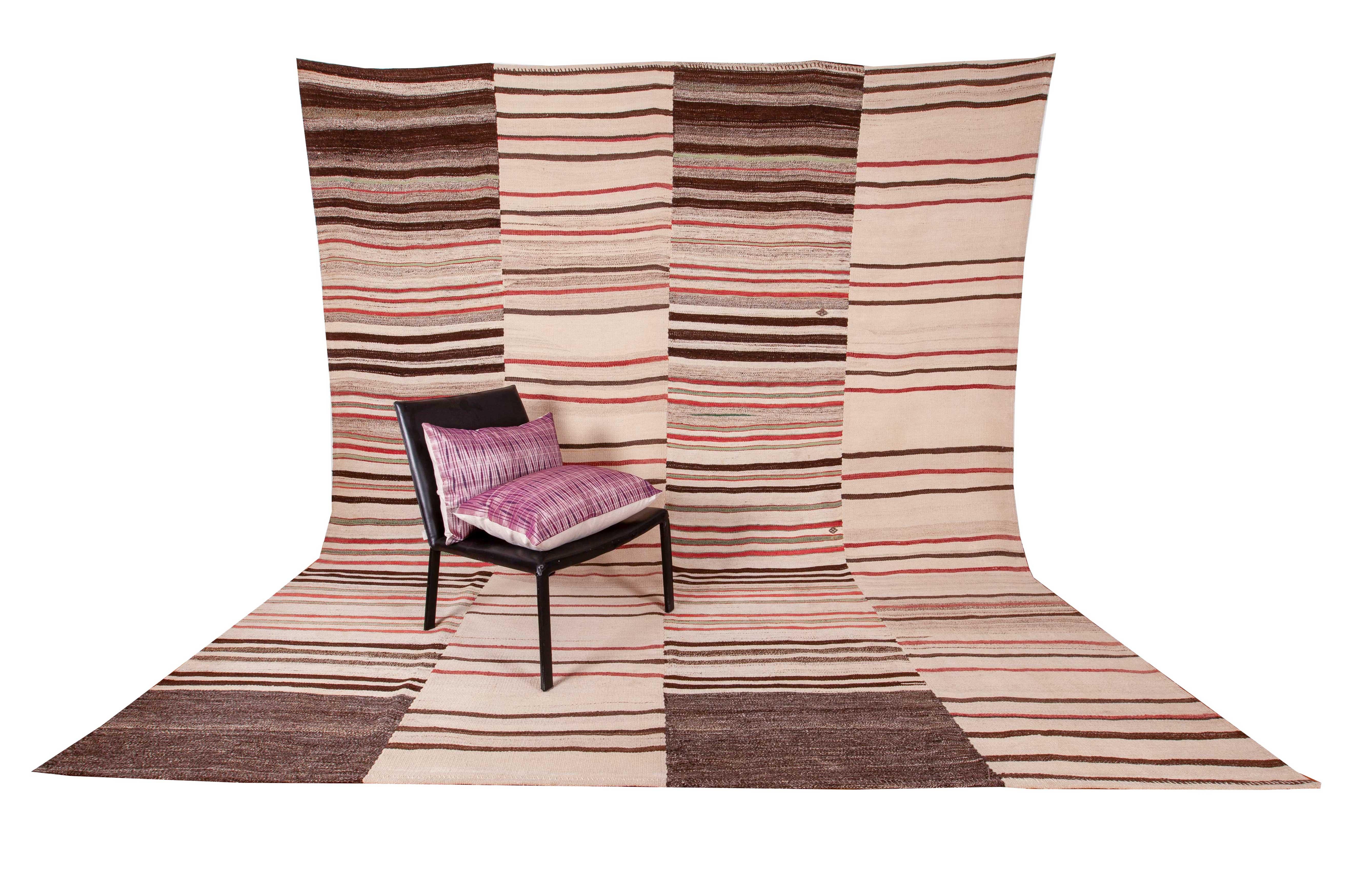 It is pure wool and in good condition. Panels of two different kilims woven at around the same time and in the same geographical region have been handstitched together to create this size.